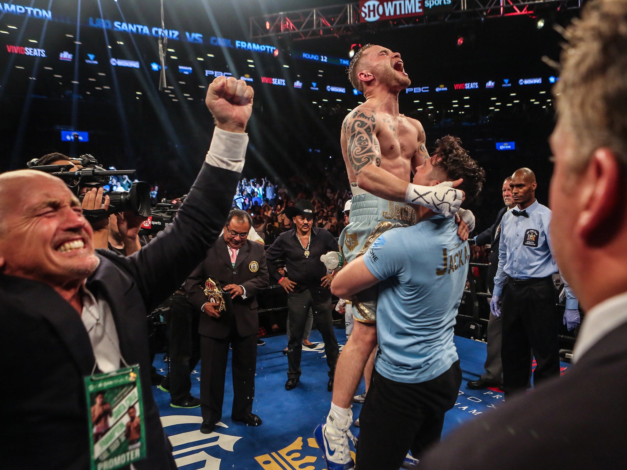 Shane McGuigan hoists Carl Frampton into the air after his victory over Leo Santa Cruz