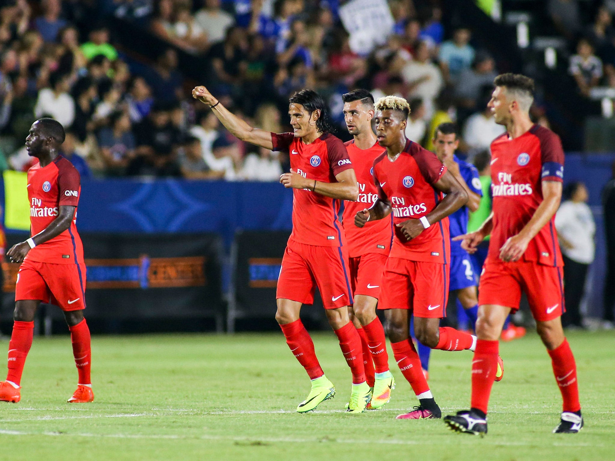 Edinson Cavani celebrates with his PSG teammates after scoring a penalty