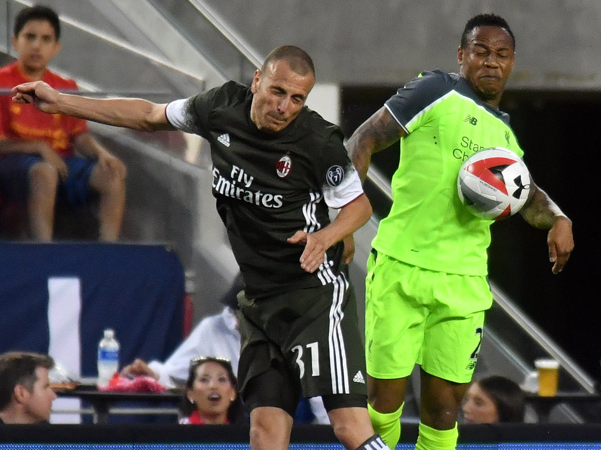 Nathaniel Clyne competes for the ball with AC Milan's Luca Antonelli