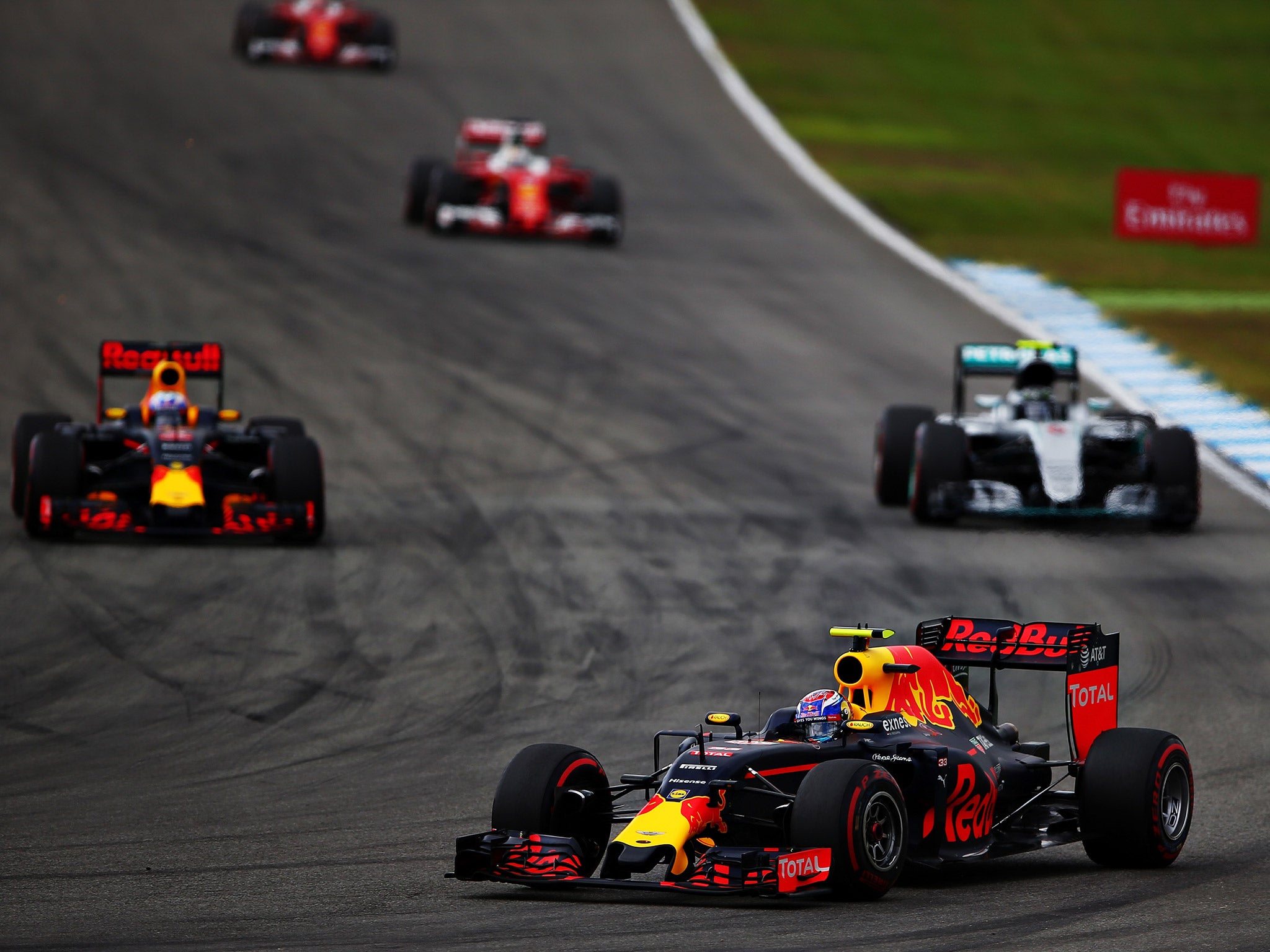 Verstappen heads into the turn six hairpin as Rosberg challenges Ricciardo behind