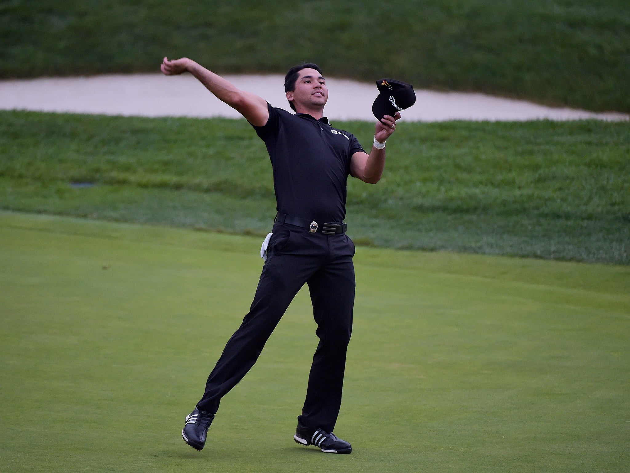 Jason Day throws his ball to the gallery after finishing his round on the 18th green