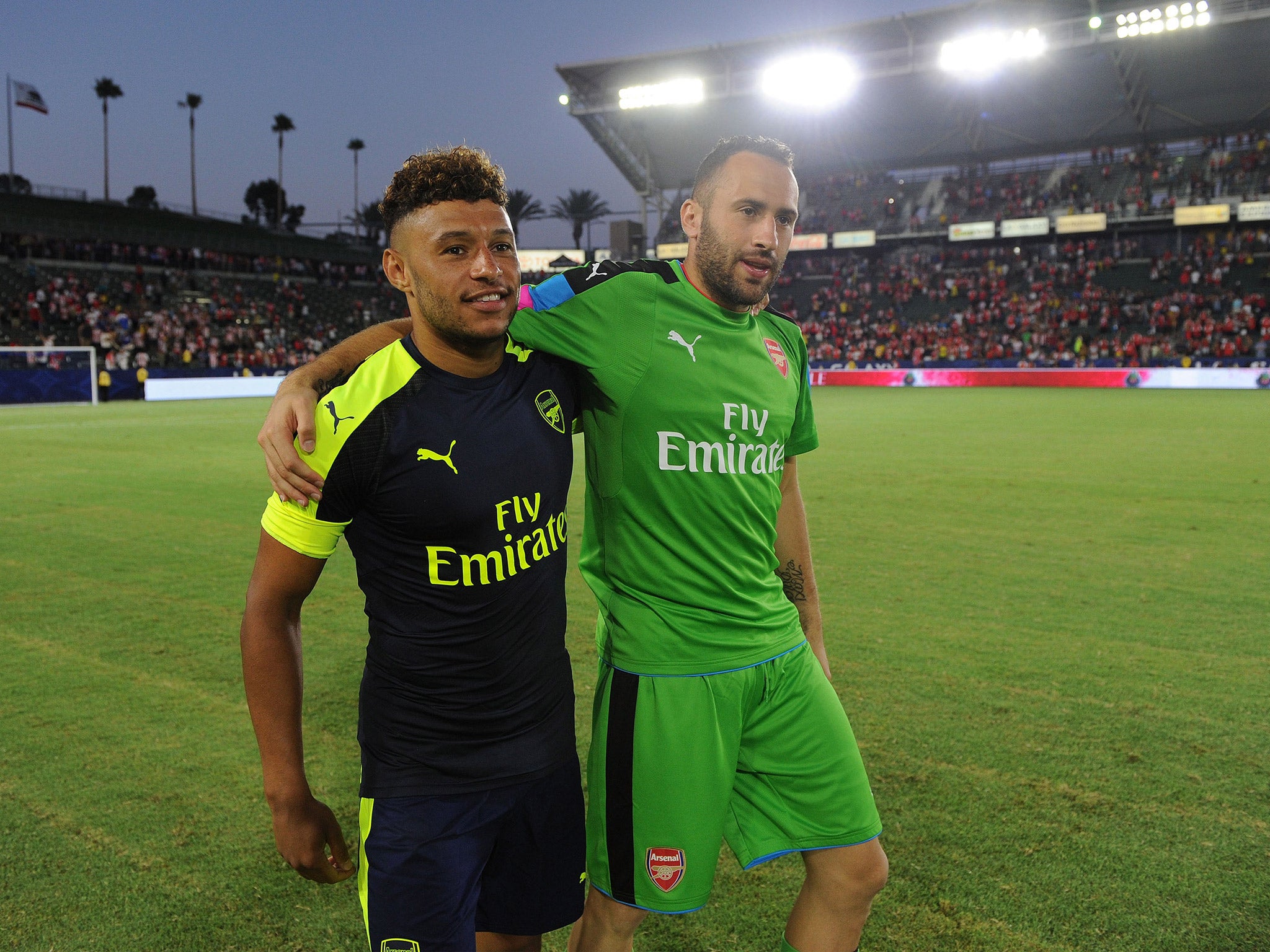 Alex Oxlade-Chamberlain celebrates with Arsenal goalkeeper David Ospina