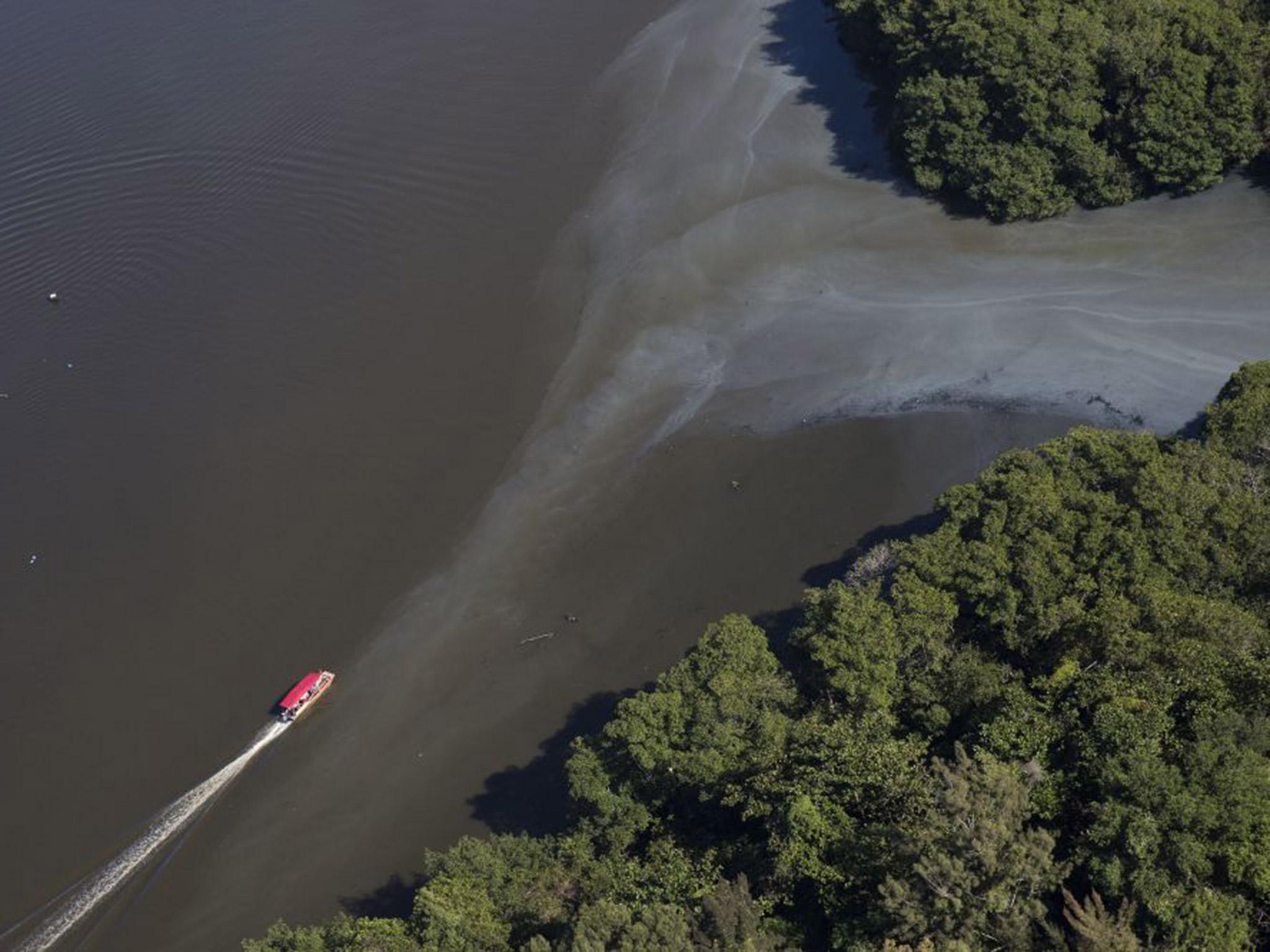 Sewage moving into the canals that rims the Barra de Tijuca neighborhood near Olympic Park