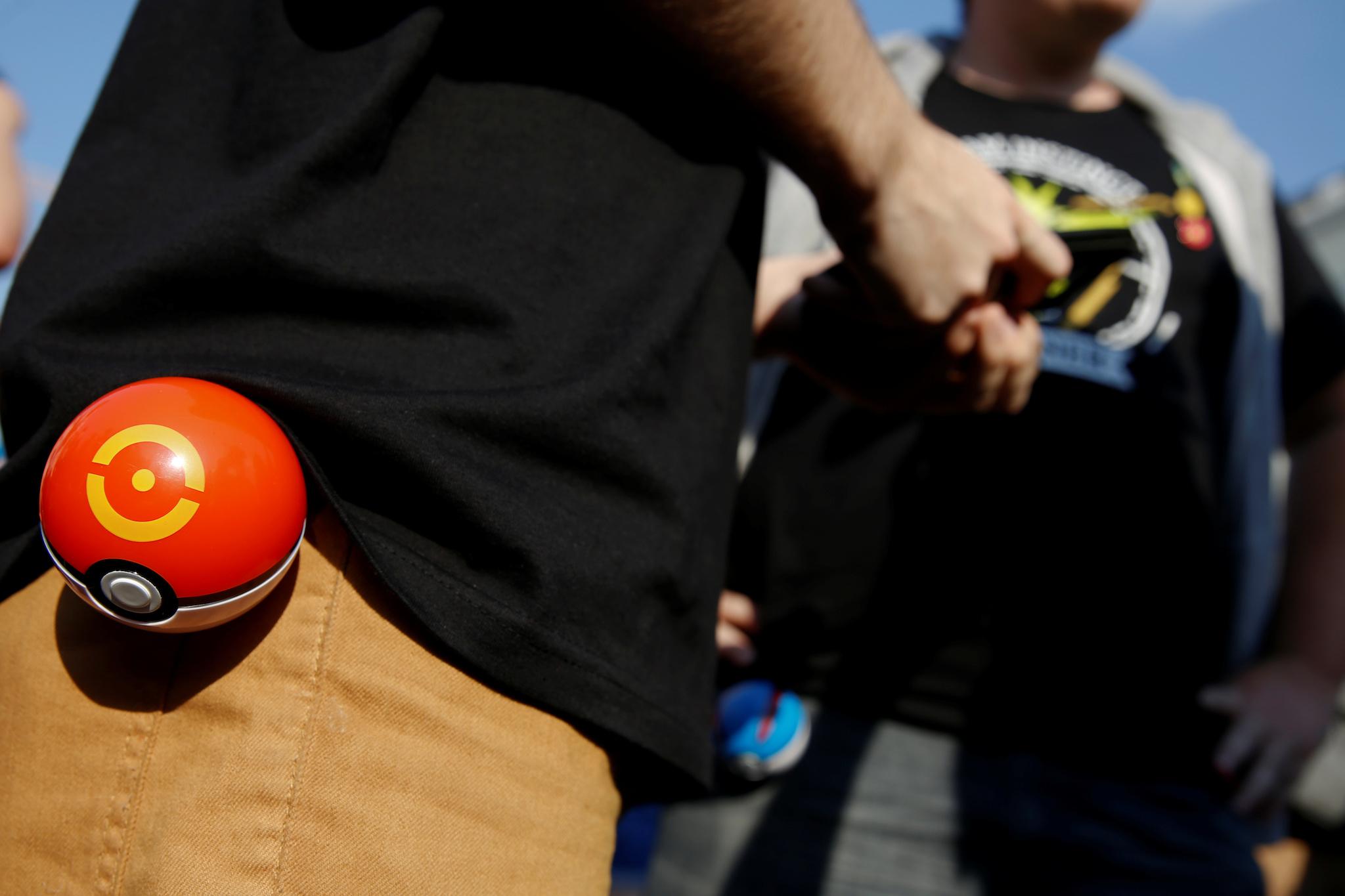 A young man plays the augmented reality mobile game "Pokemon Go" by Nintendo at Puerta del Sol square in Madrid, Spain