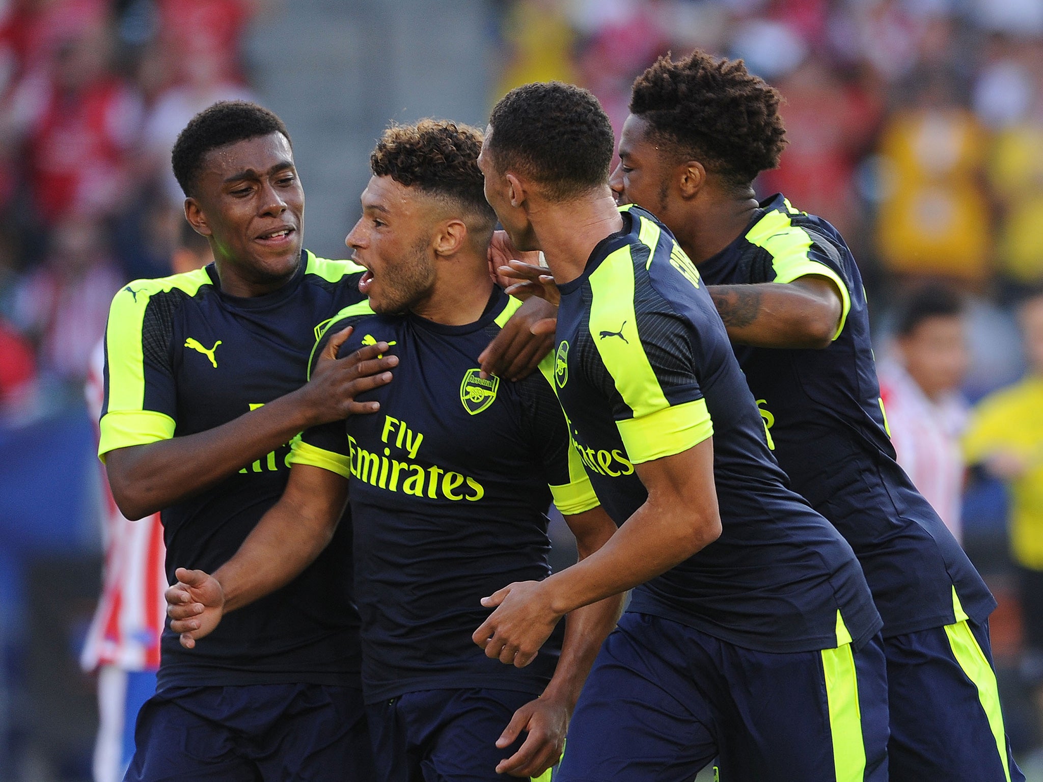 Oxlade-Chamberlain celebrates scoring against Chivas