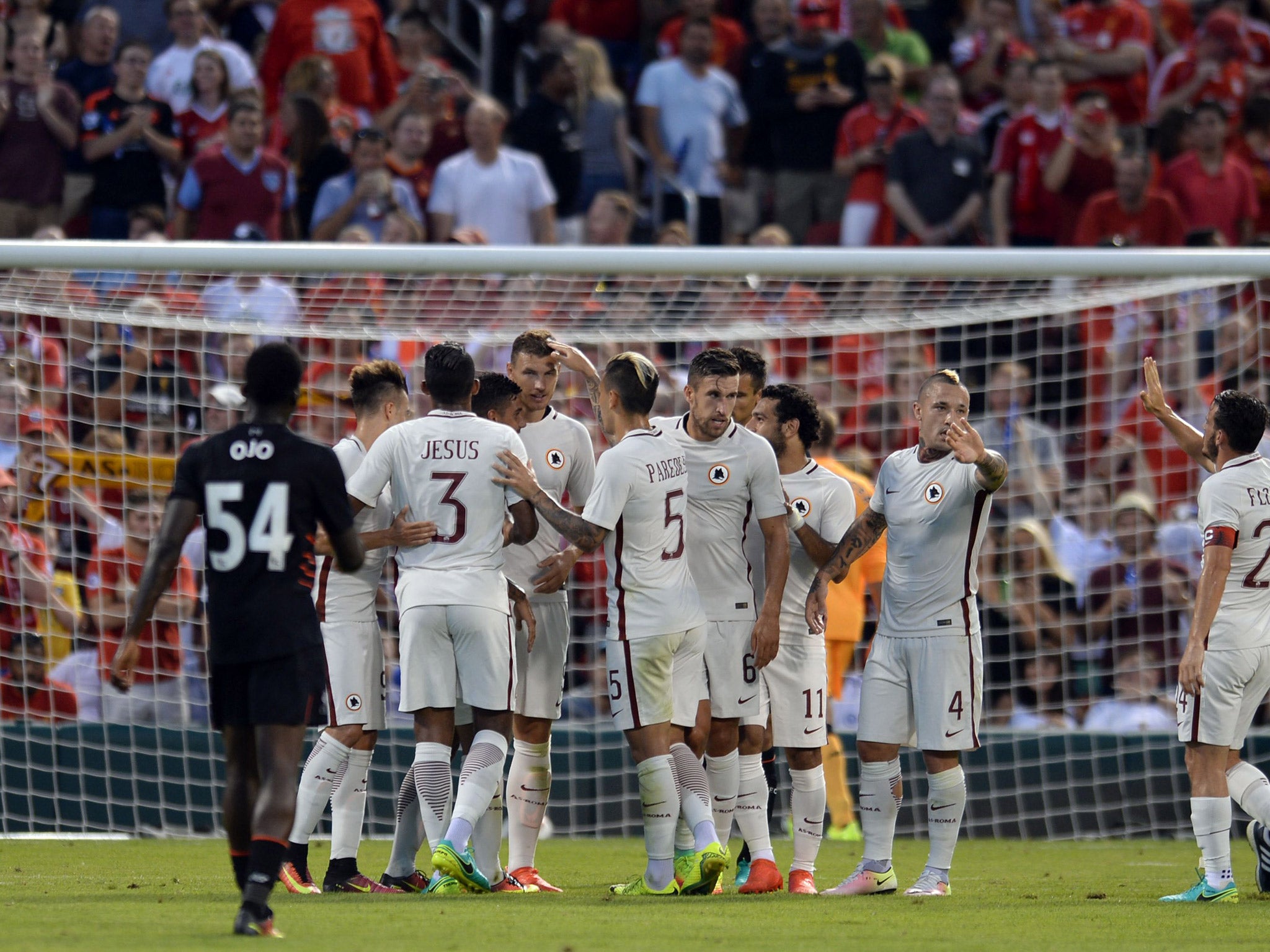 Roma players celebrate after Edin Dzeko scores against Liverpool