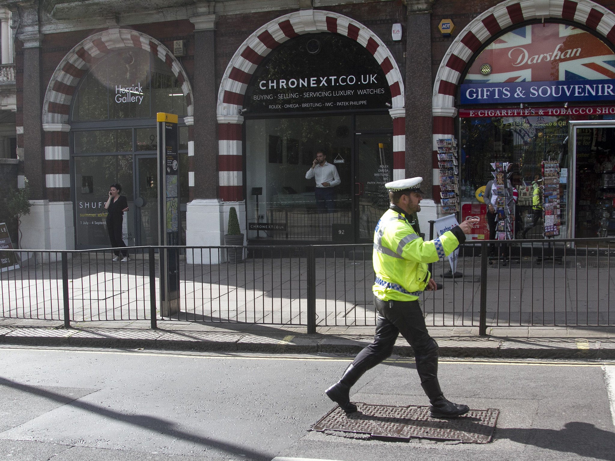 Police cordon off the area after an attempted smash and grab raid on the upmarket watch store