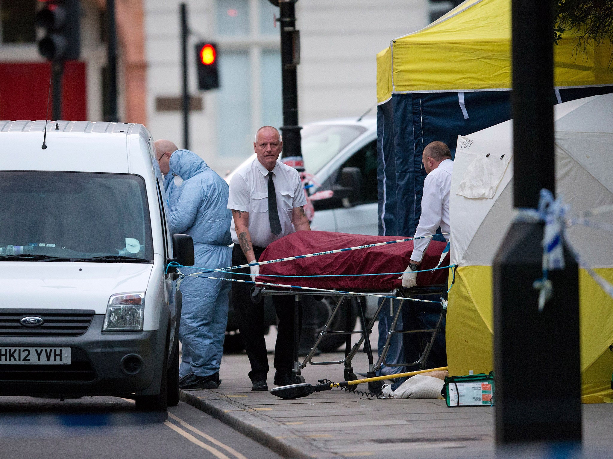 Police move the woman's body from the crime scene in Russell Square on Thursday (AFP/Getty )