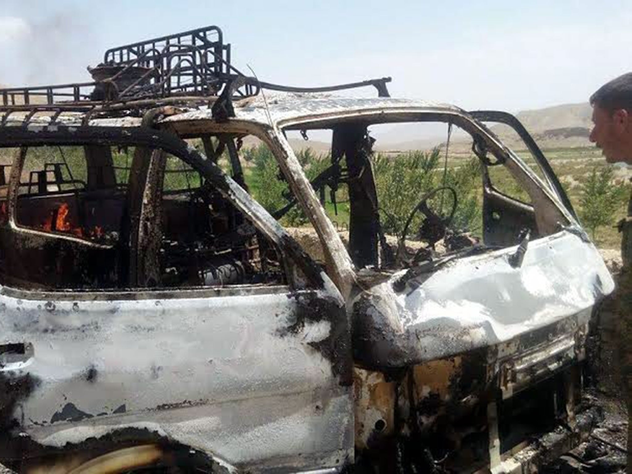 The van that is believed to have been transporting foreign tourists after it was hit by a rocket propelled grenade in Afghanistan