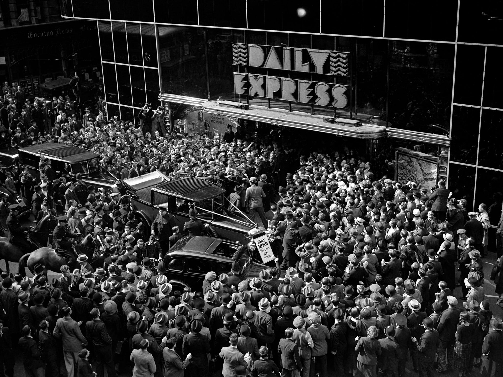 &#13;
Crowds gather round the entrance to the ‘Daily Express’ building to greet English aviator Amy Johnson after her record solo flight to Cape Town in 1932 &#13;