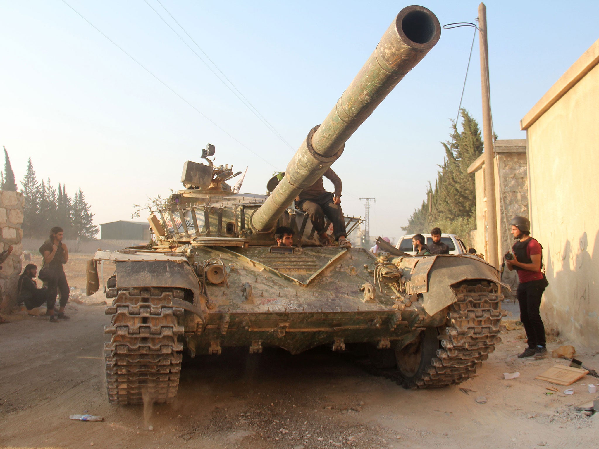 Fighters from the former Al-Nusra Front -- renamed Jabhat Fateh al-Sham after breaking from Al-Qaeda -- drive a tank as they seized key positions south of Aleppo in August 6, 2016 in