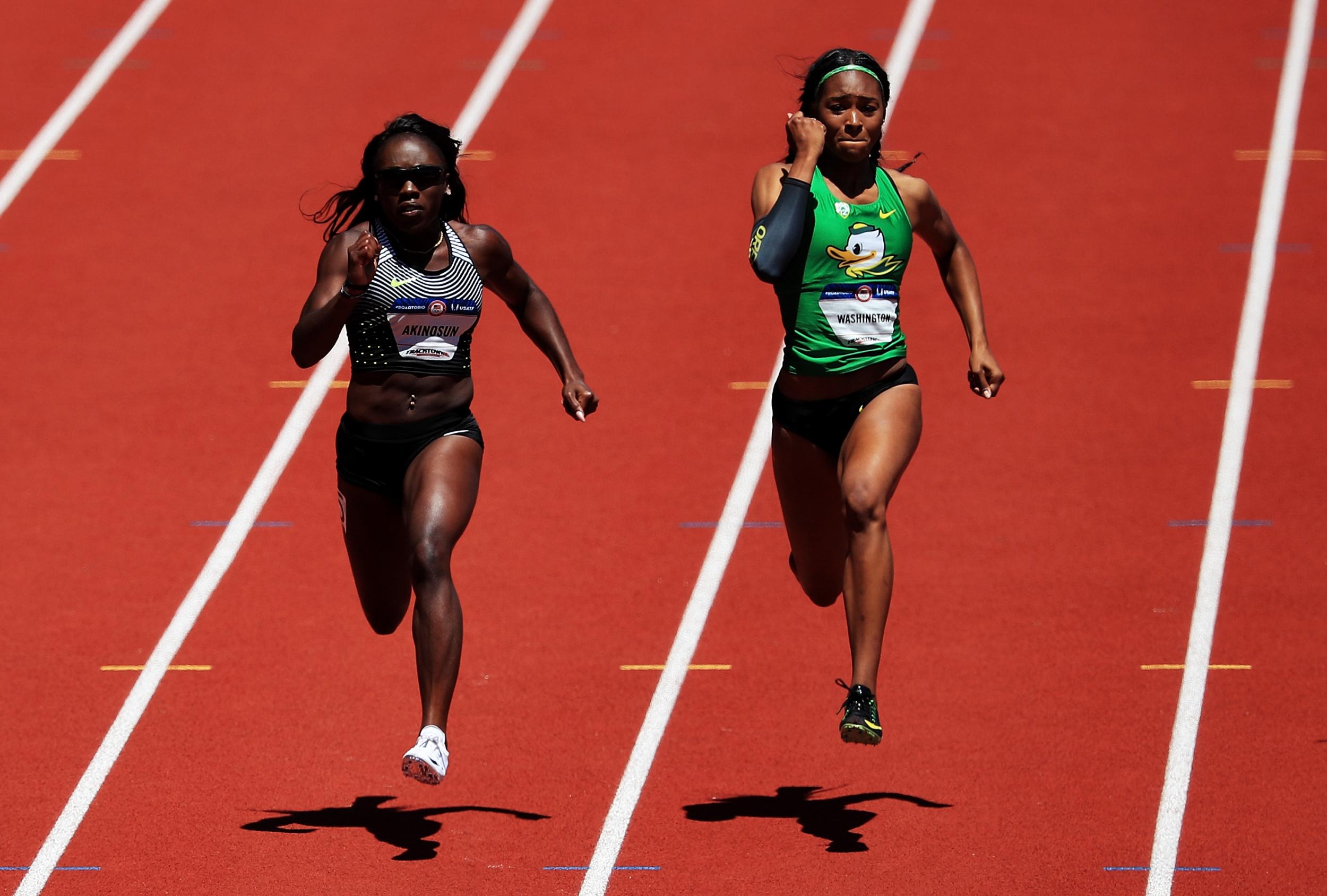 Morolake Akinosun (L) and Ariana Washington (R) run in the first round of the Women's 100 Meter's Dash during the 2016 U.S. Olympic Track & Field Team Trials