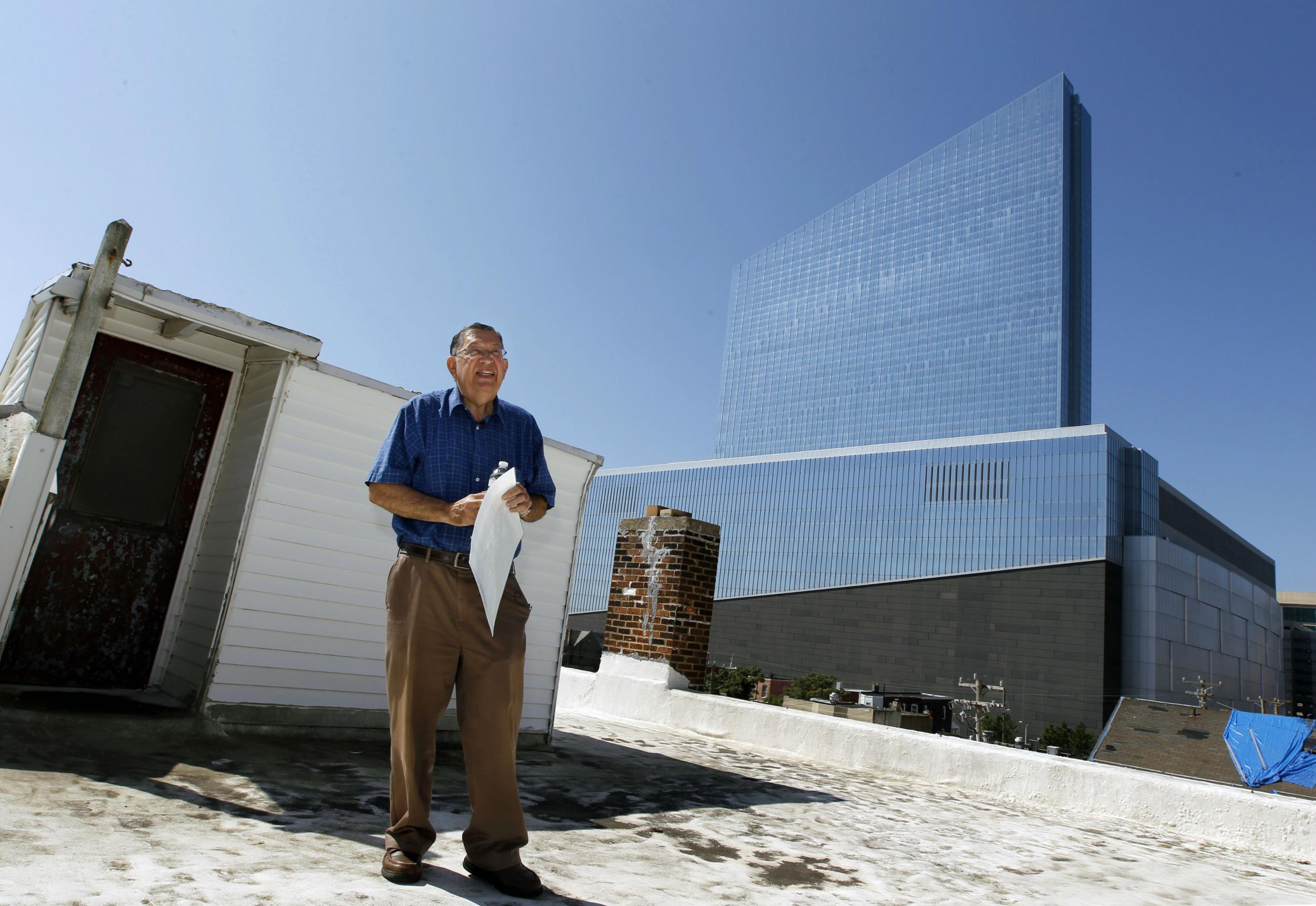 Charlie Biernbaum on the roof of his house with the Revel Hotel behind him