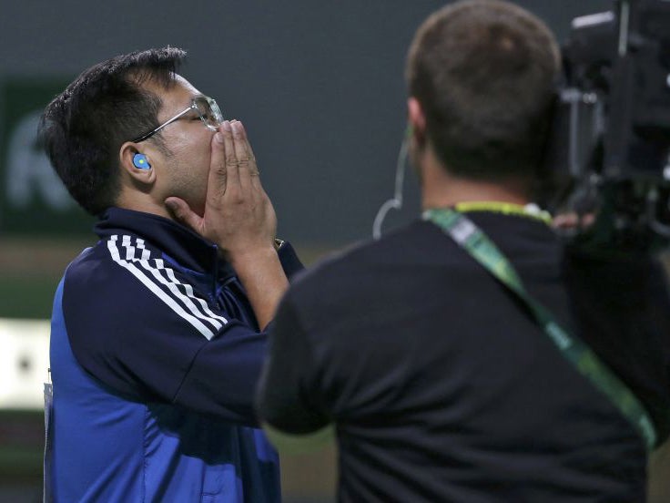 Hoang Xuan Vinh of Vietnam reacts after winning gold