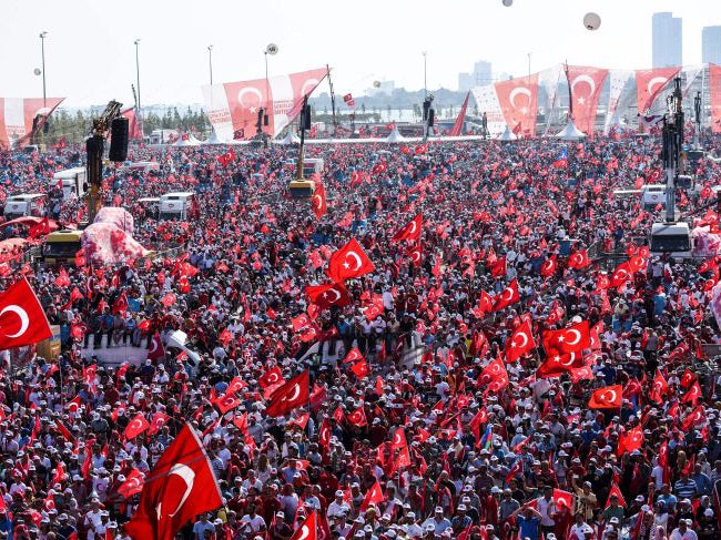 Demonstrators wave Turkish national flags on August 7, 2016 in Istanbul during a rally against failed military coup on July 15