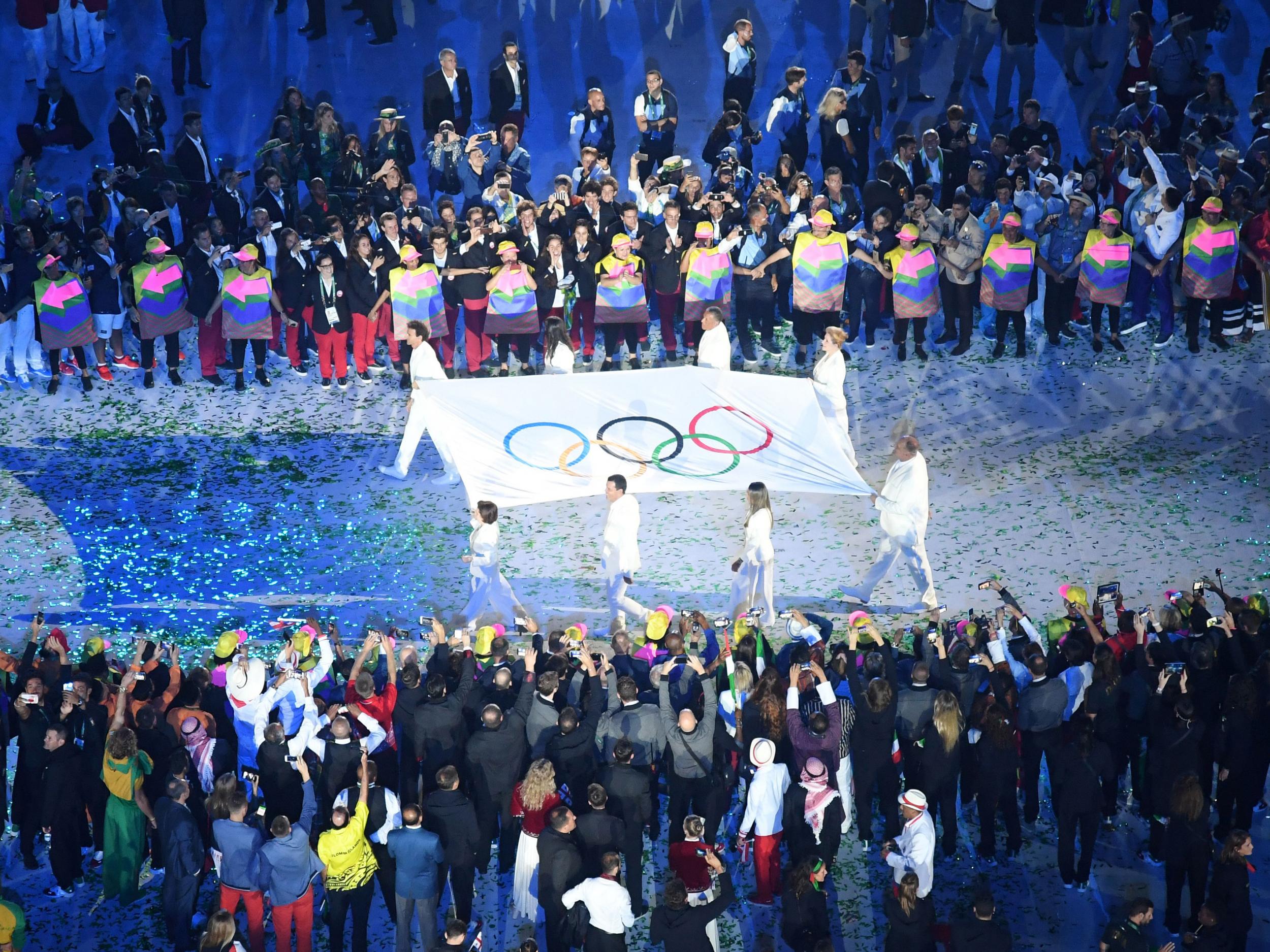 The Olympic flag is carried before being raised during the opening ceremony of the Rio 2016 Olympic Games at the Maracana stadium in Rio de Janeir