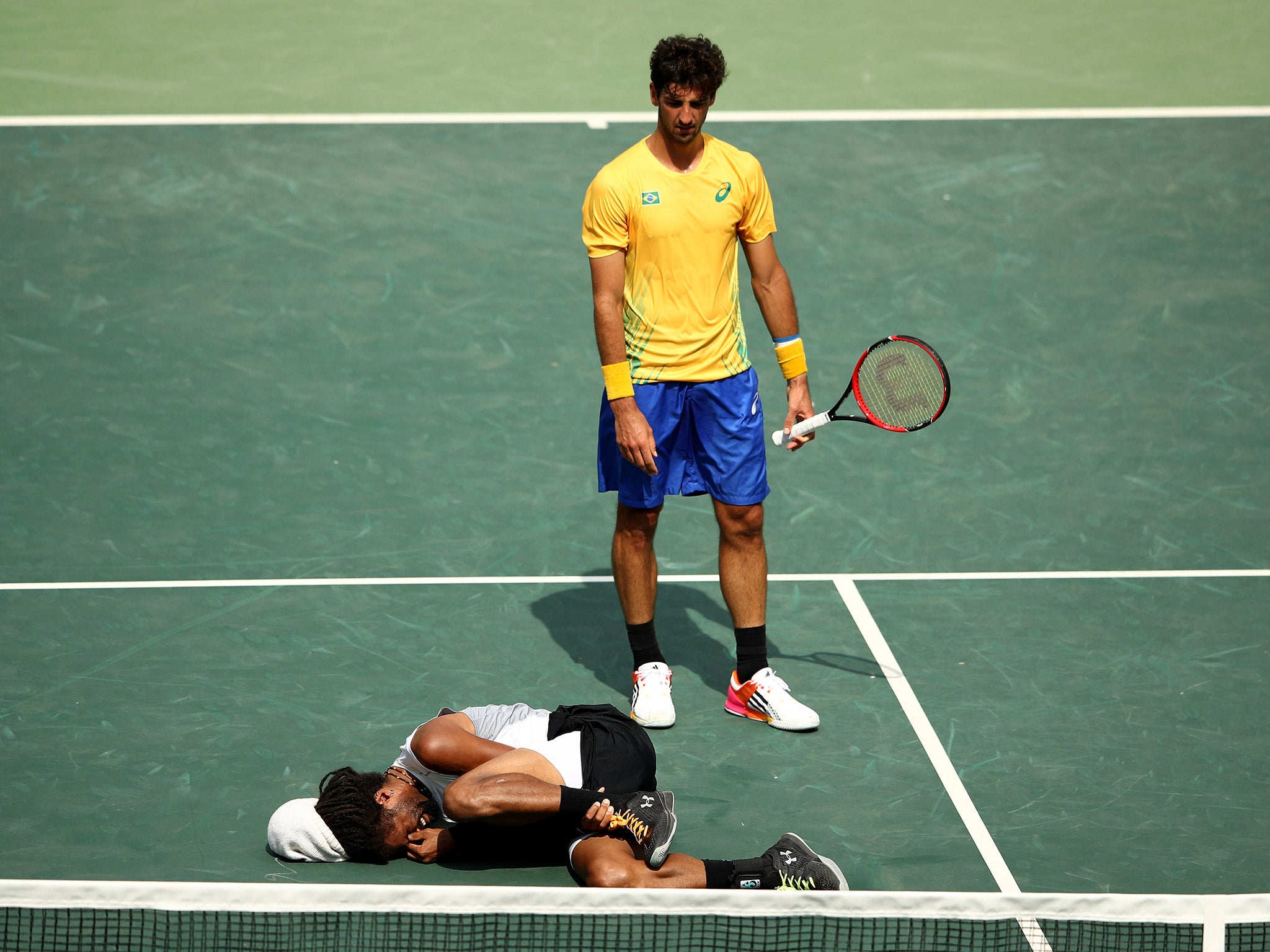 Dustin Brown holds his ankle in agony after suffering injury