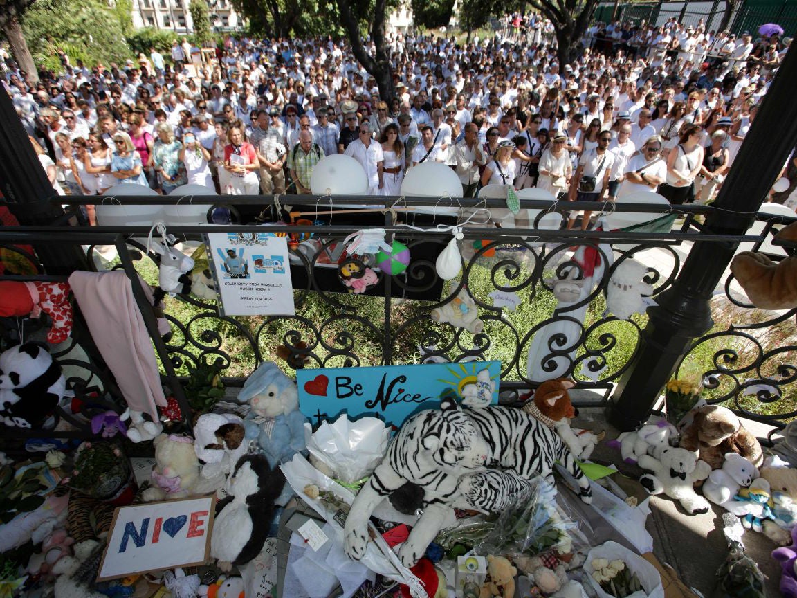 People dressed in white attend a minute of silence held for the victims of the Bastille Day attack in the city of Nice