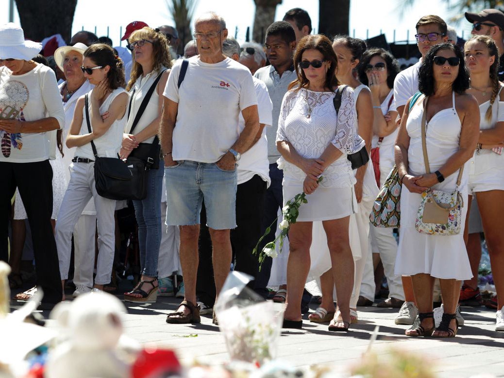 People dressed in white attend a minute of silence held for the victims of the Bastille Day attack