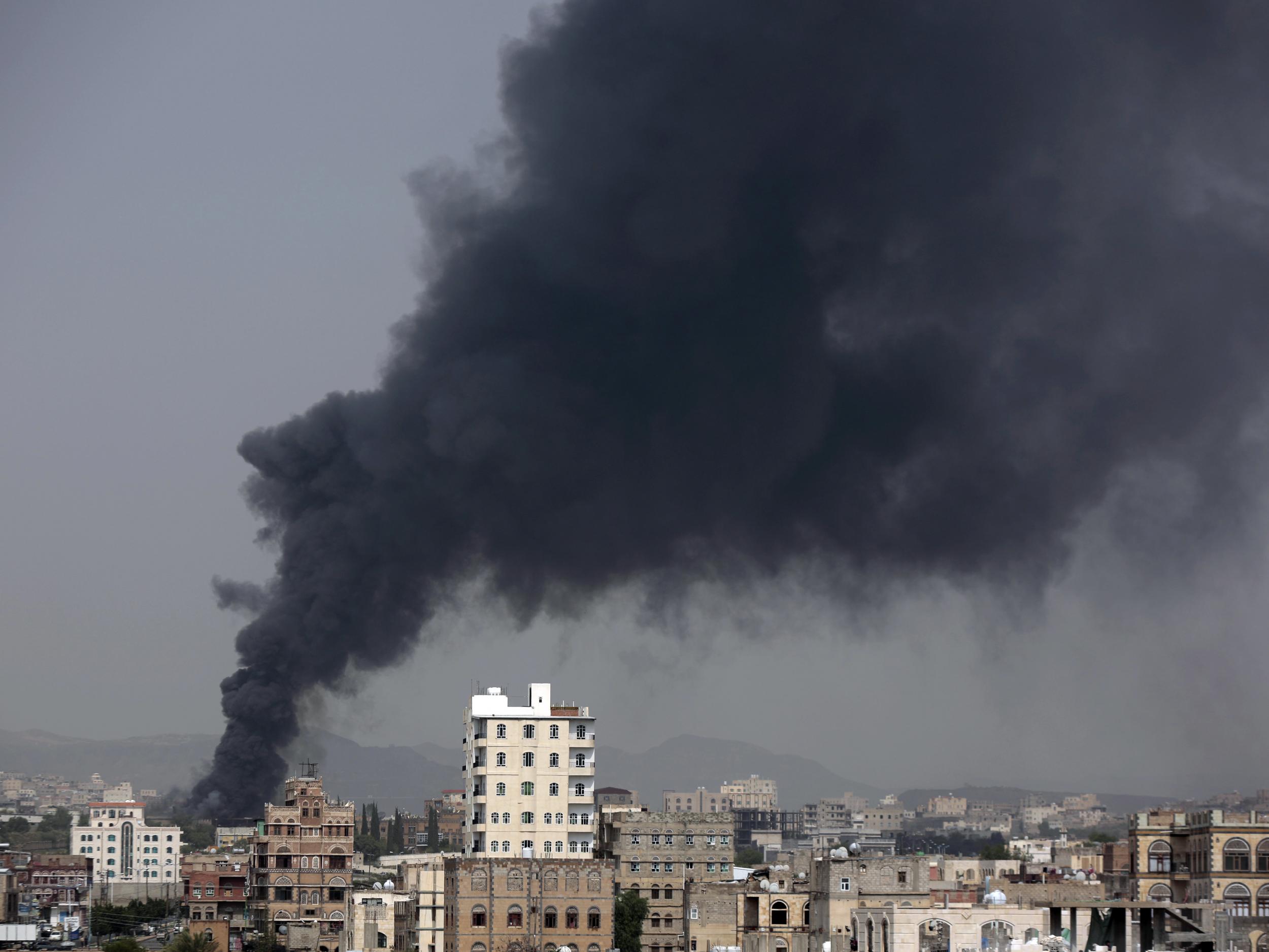 Smoke rises from a food factory in Sanaa where 14 workers were killed