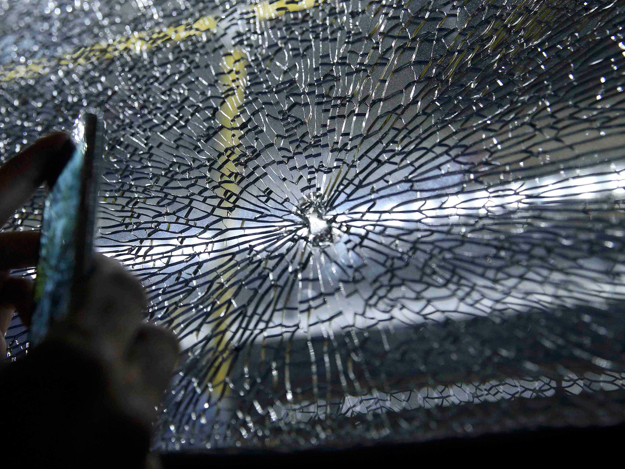 A broken window on an official media bus after it shattered when driving journalists to the main Olympic Park from Deodoro in Rio de Janeiro on 9 August