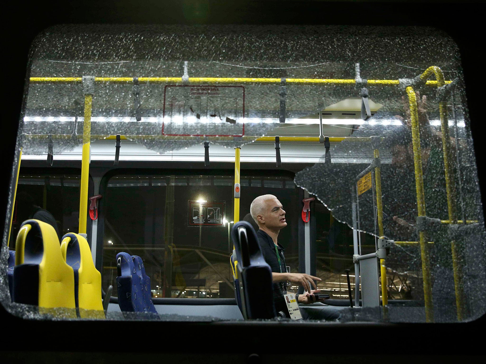 A broken window on an official media bus after it shattered when driving journalists to the main Olympic Park from Deodoro in Rio de Janeiro on 9 August