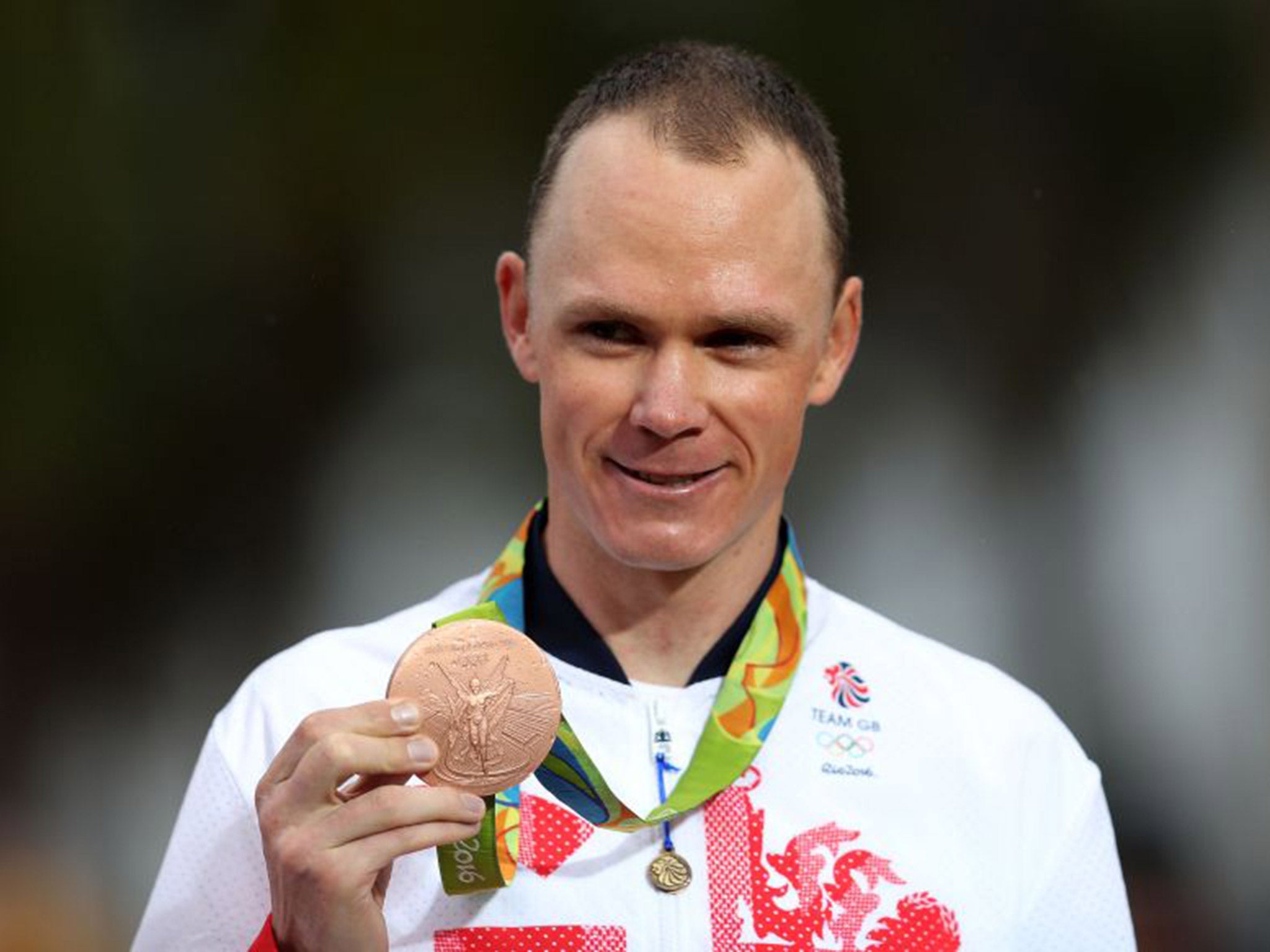 Chris Froome presents his bronze medal after the men's time trial