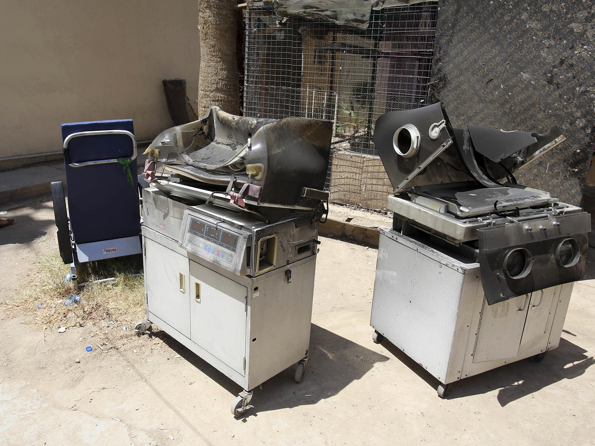 Burned incubators for newborn babies are dumped outside a maternity ward after a fire at Yarmouk hospital in western Baghdad, Iraq