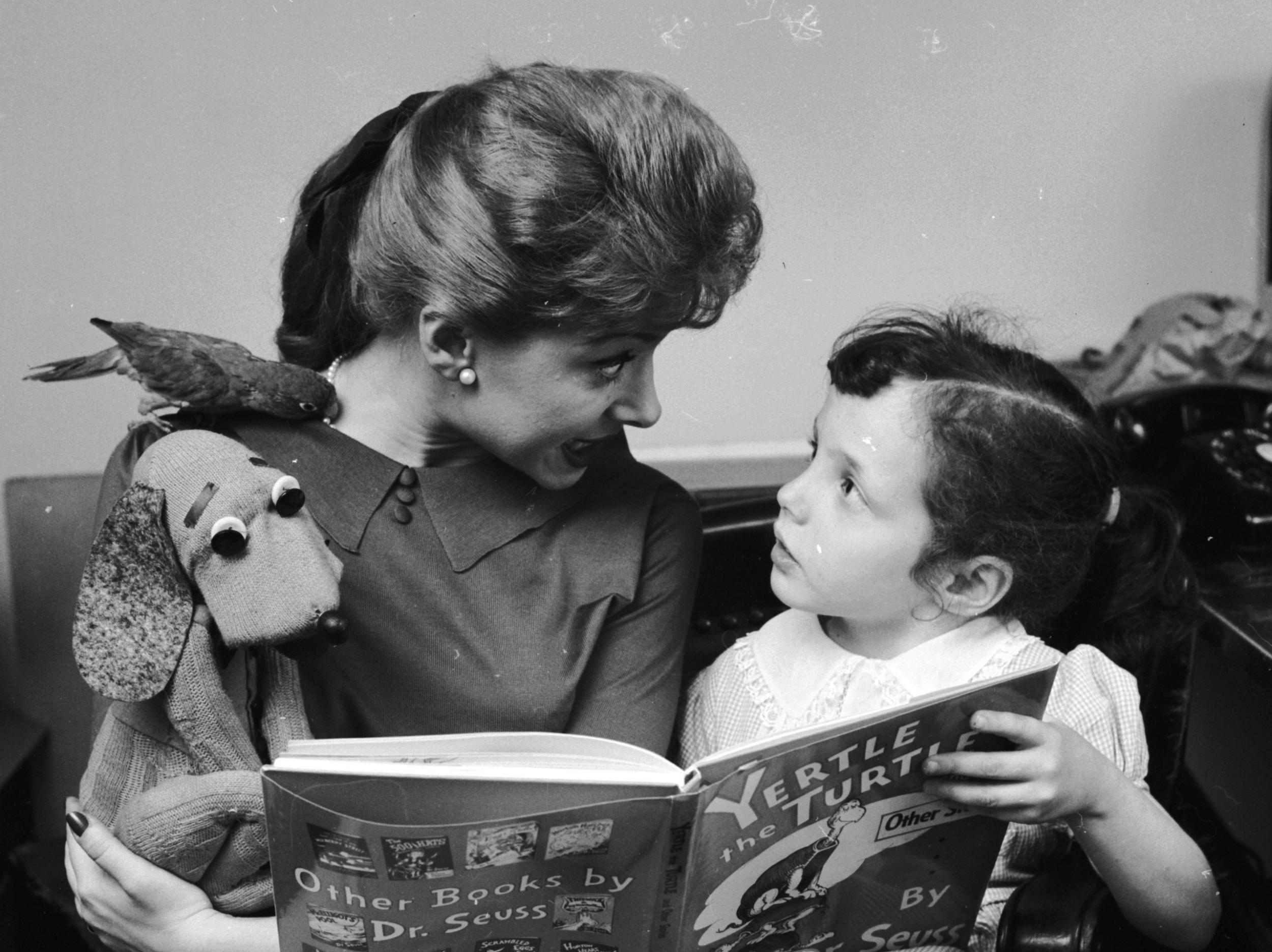 American television personality Shari Lewis reads the tale of Yertle the Turtle to a young girl