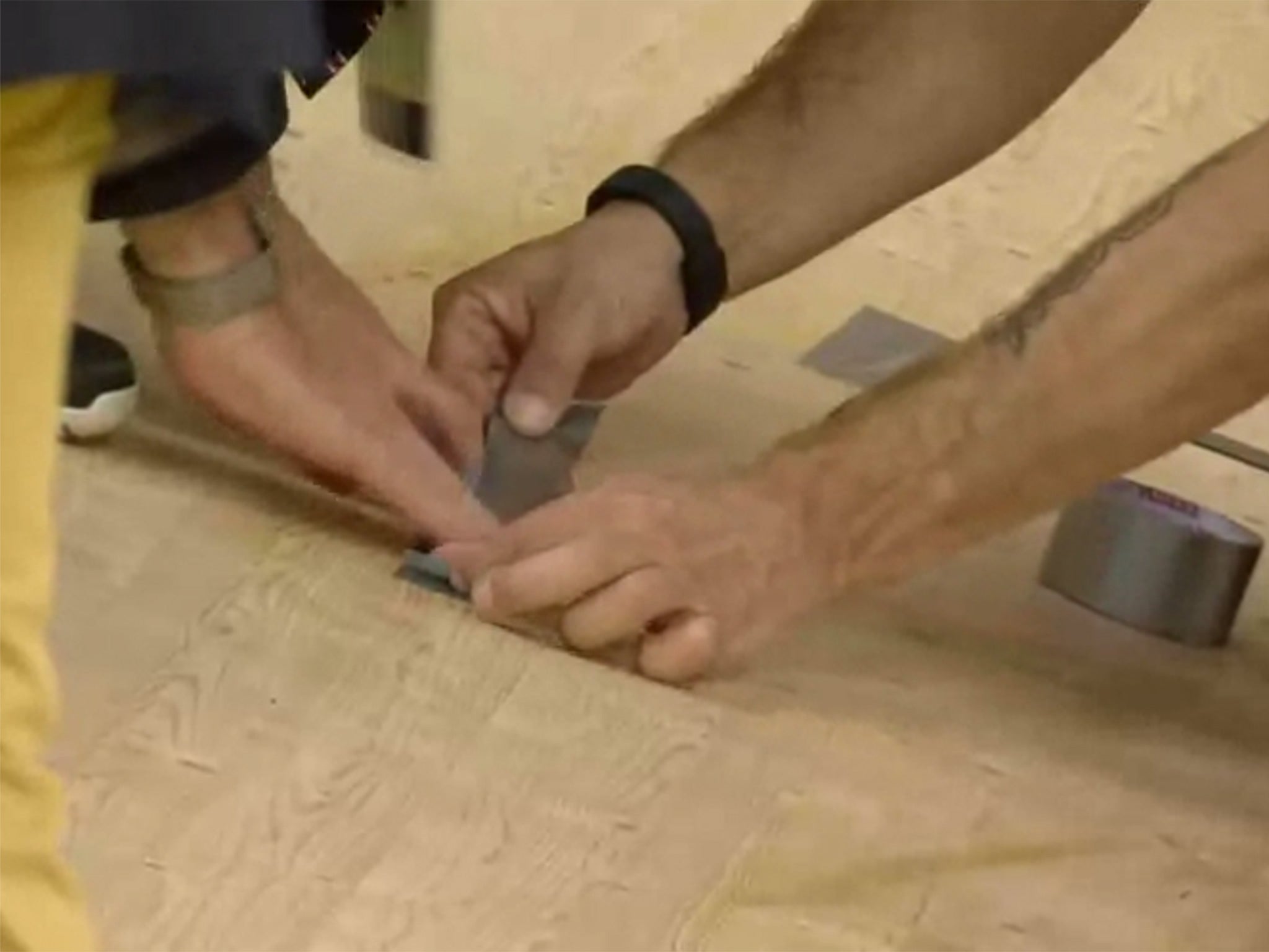 Organisers repair a hole in the track with duct tape