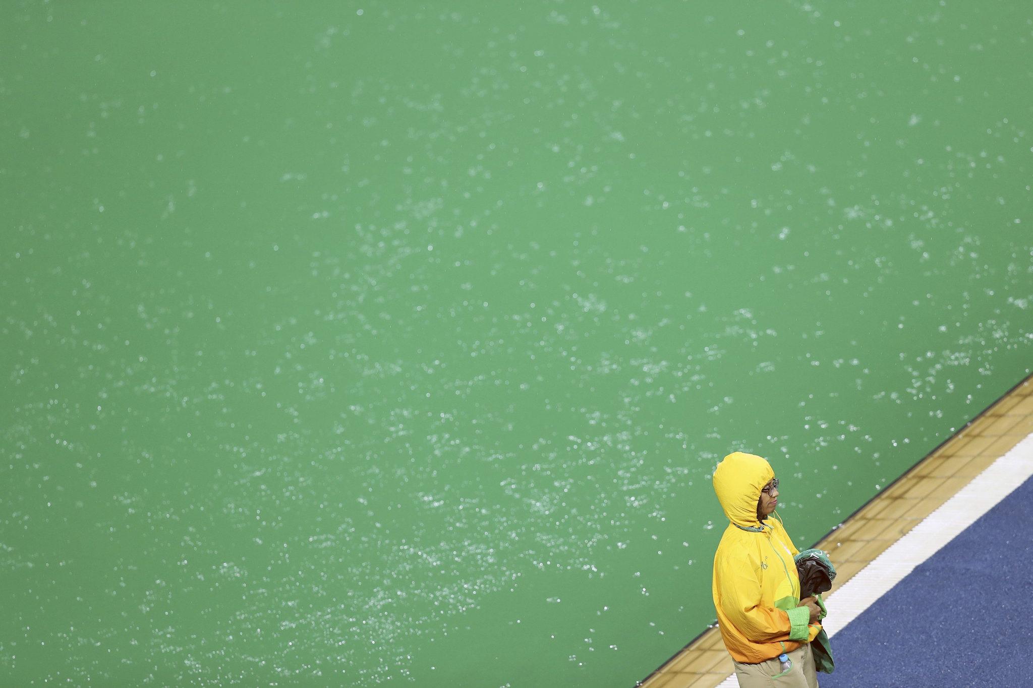 A volunteer stands next to the pool