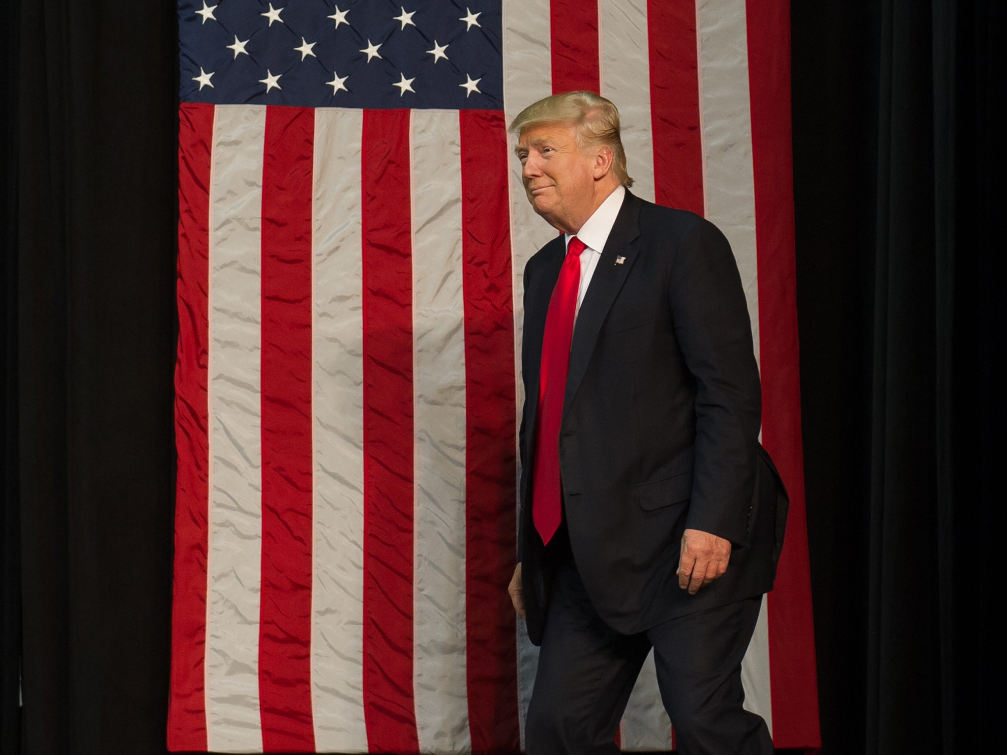 Donald Trump takes to the stage at a rally in Erie, Pennsylvania, on August 12