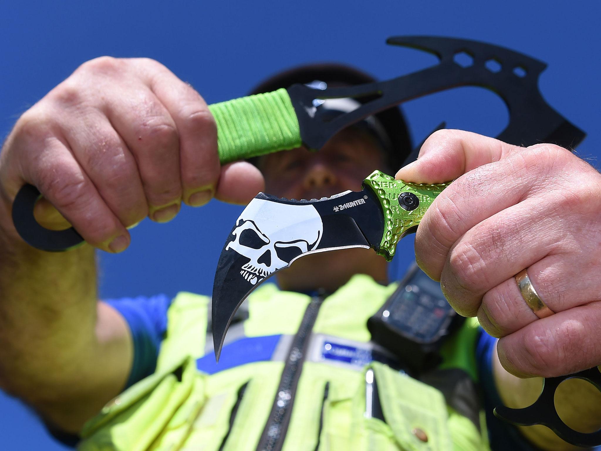 West Midlands PCSO Rob Capella holds two examples of zombie knives at a secure police location in Birmingham