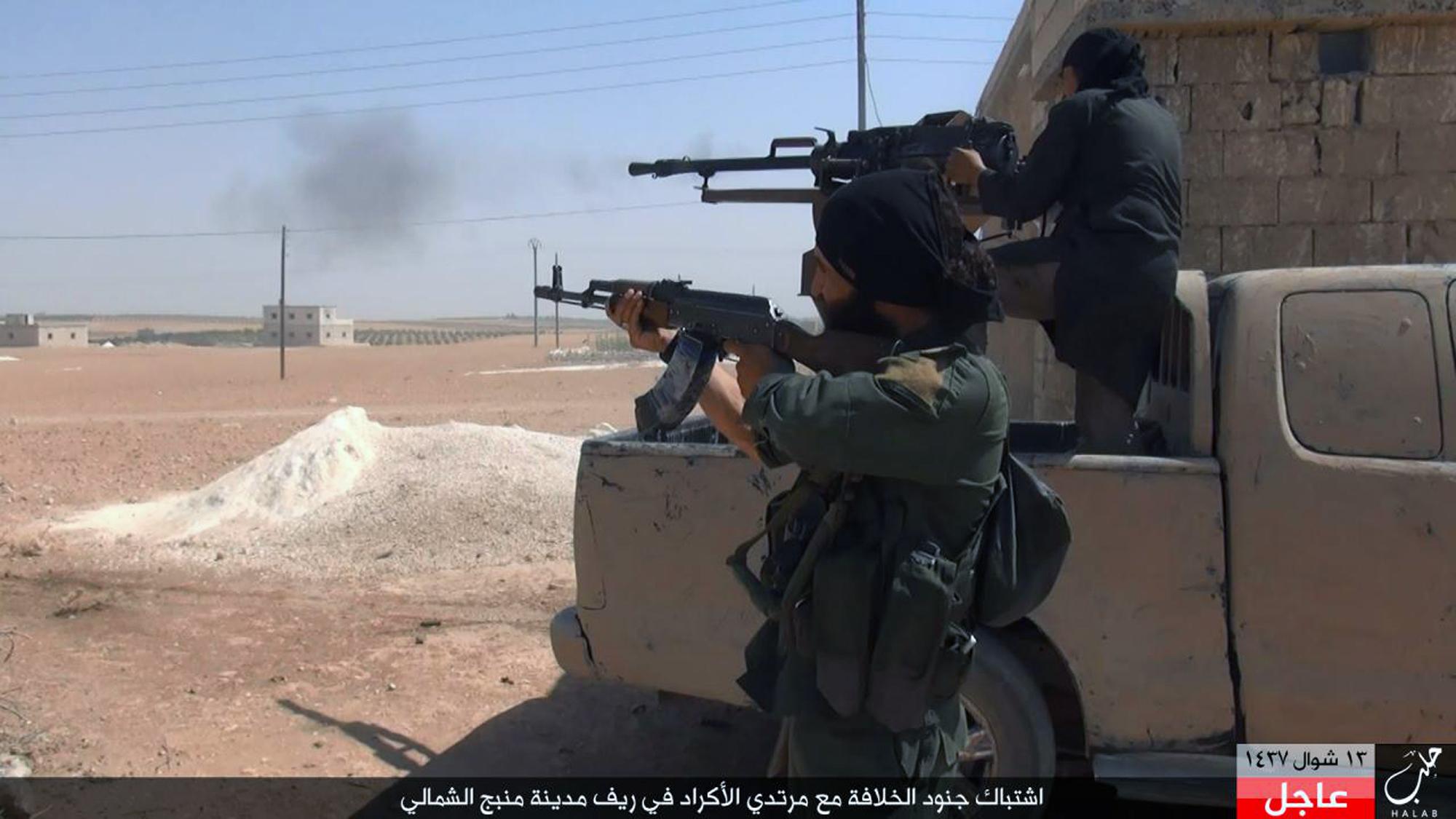 Isis fighters open fire during clashes in Manbij, Aleppo province, in an undated image posted online by their supporters