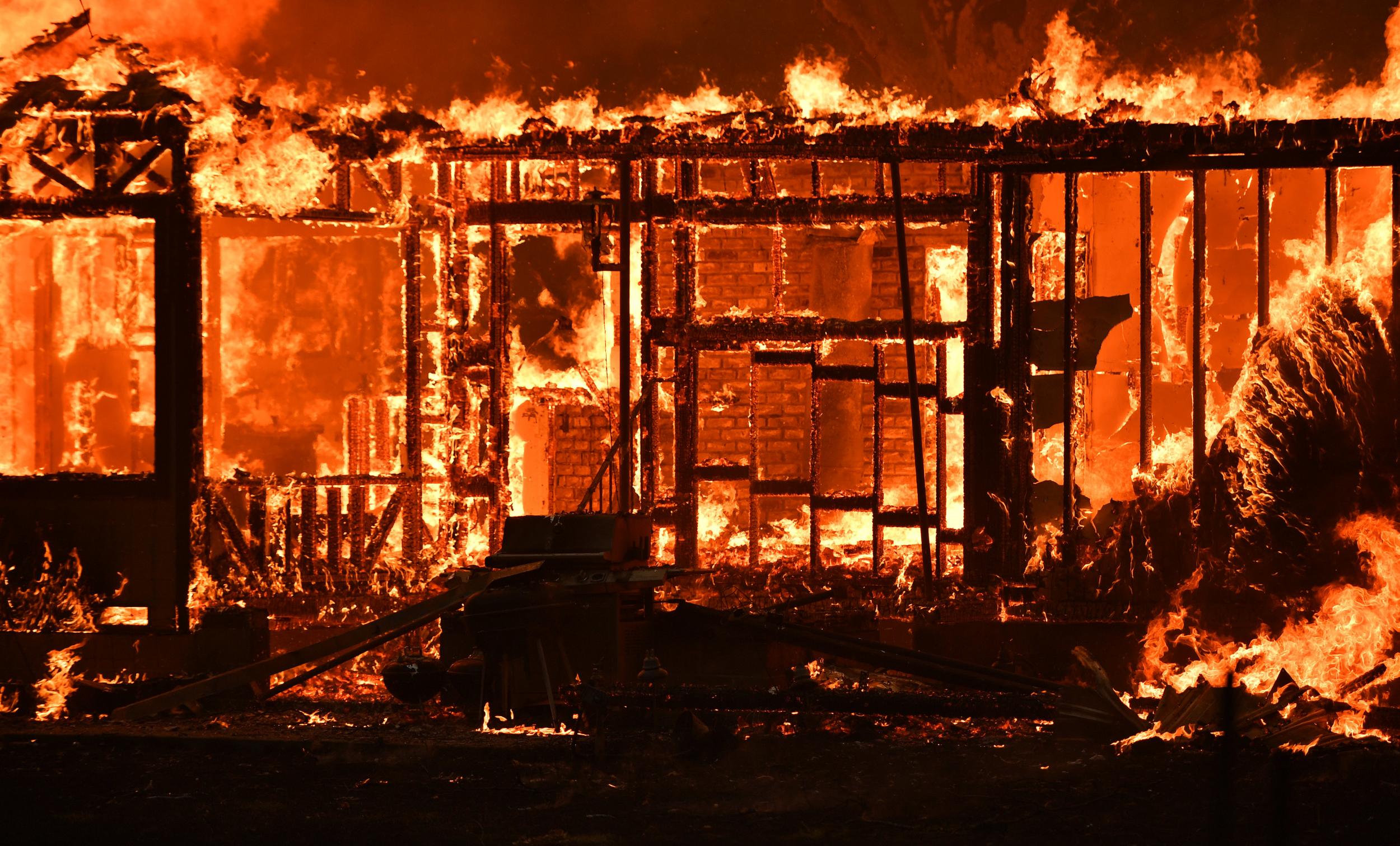 A home burns near the town of Lower Lake, California, as firefighters struggle to bring blaze under control