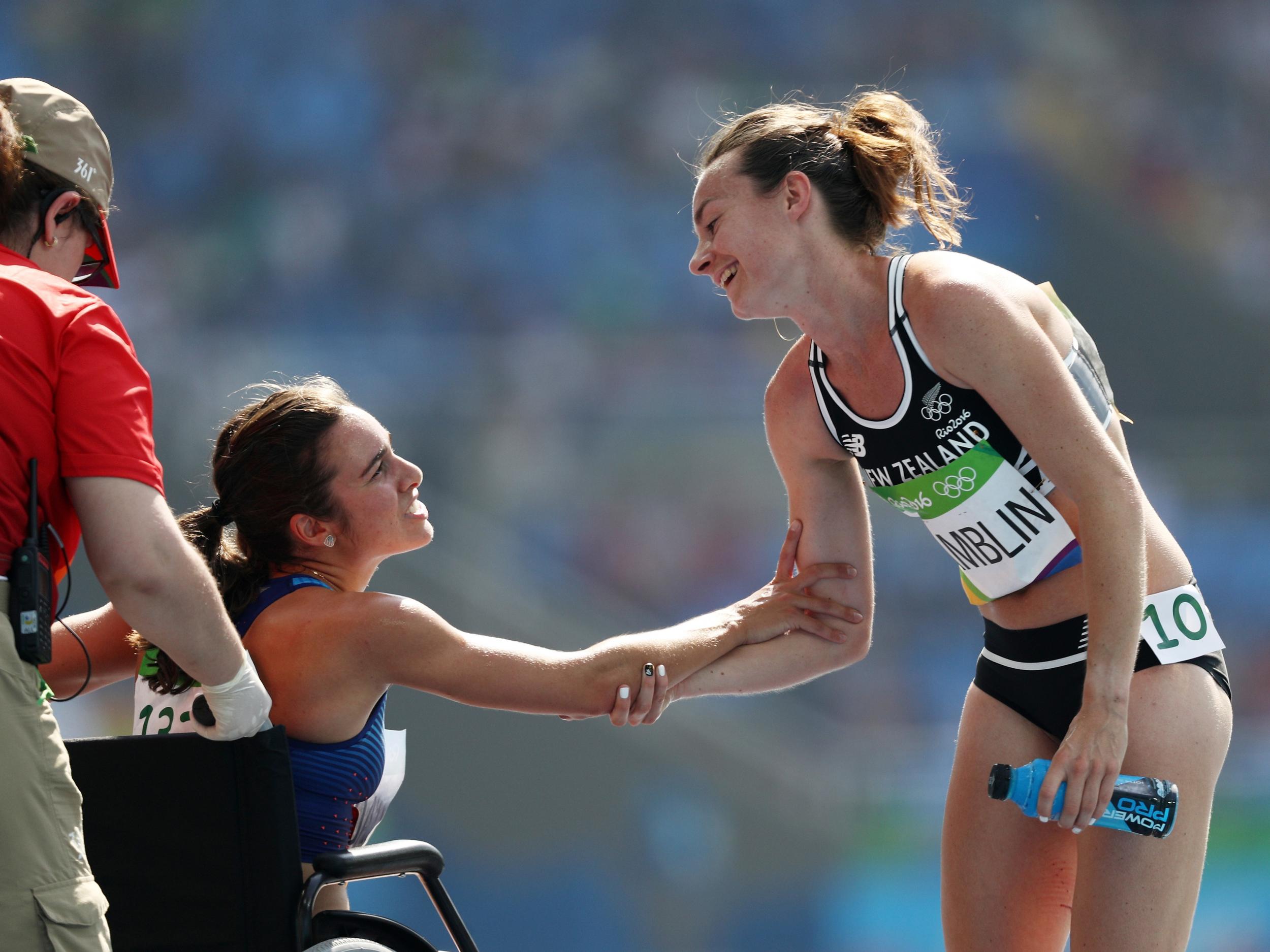 Abbey D'Agostino of the United States (L) talks with Nikki Hamblin of New Zealand