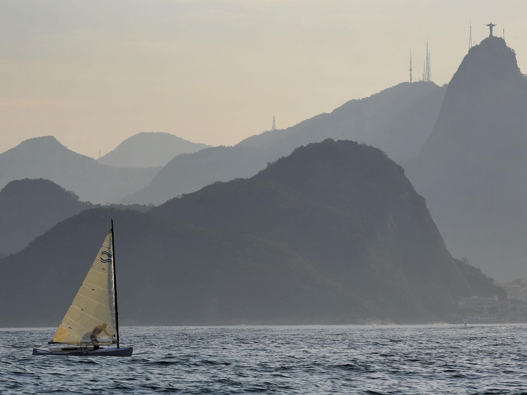 A Finn sailing vessel sails in Rio de Janeiro's Guanabara Bay