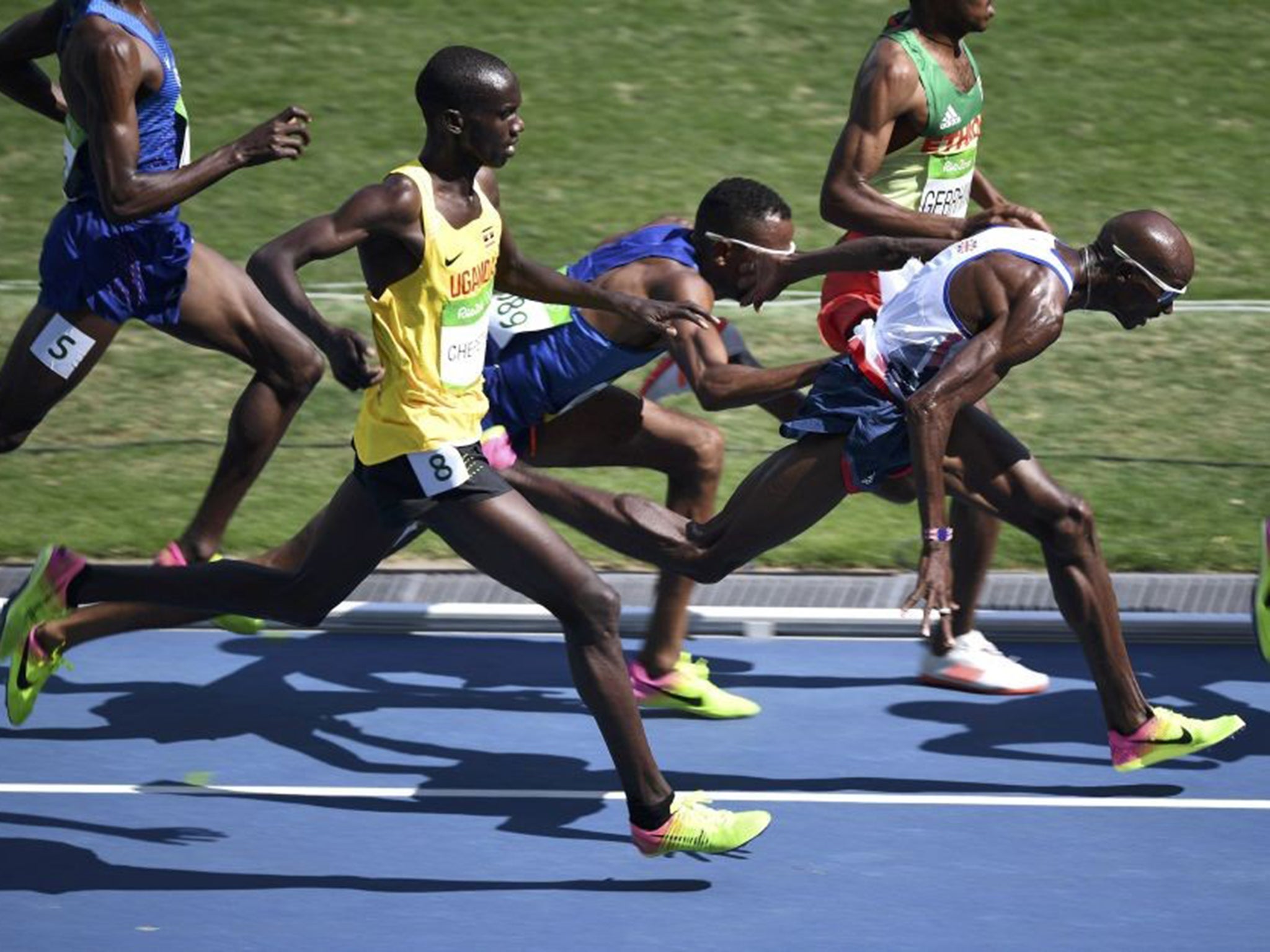 
Hassan Mead of the US collides with Farah during the 5,000m semi-final 