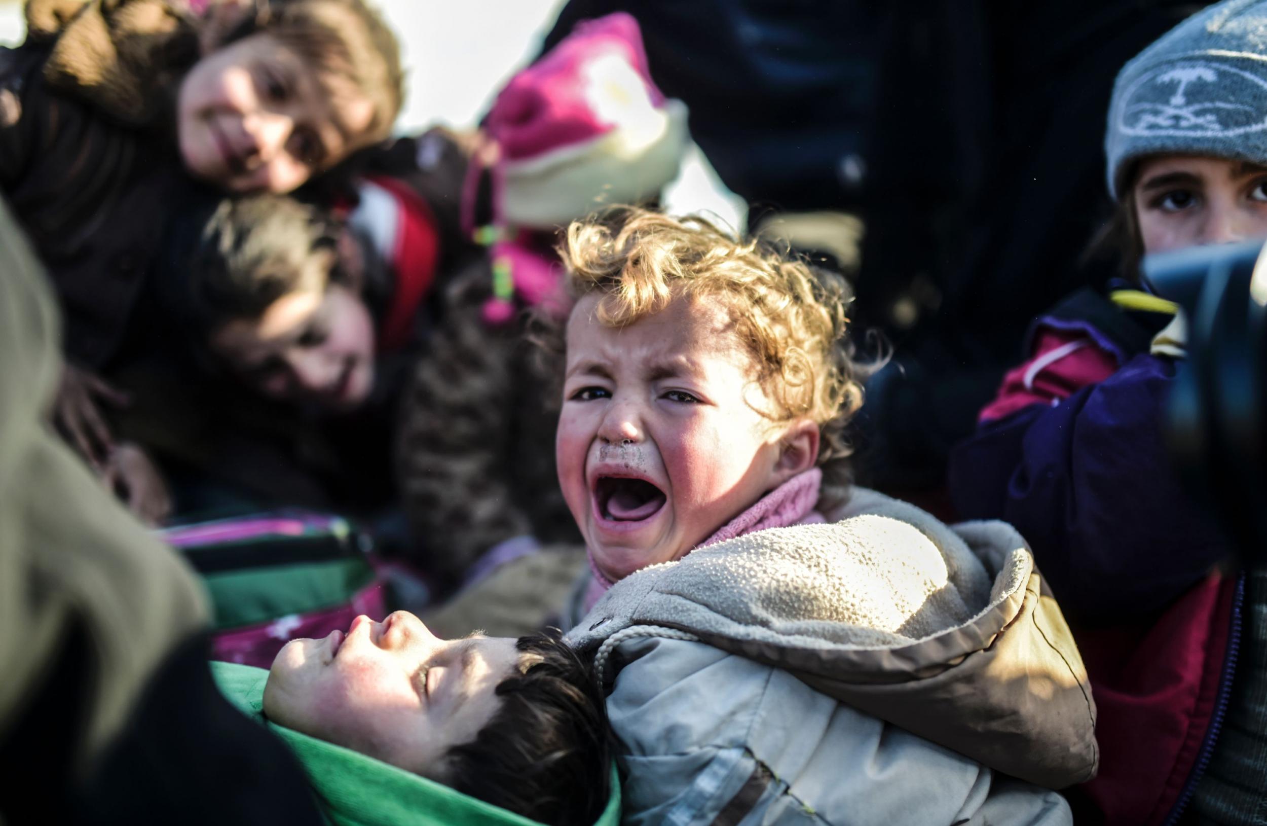 A child cries while fleeing the embattled northern city of Aleppo in 2016