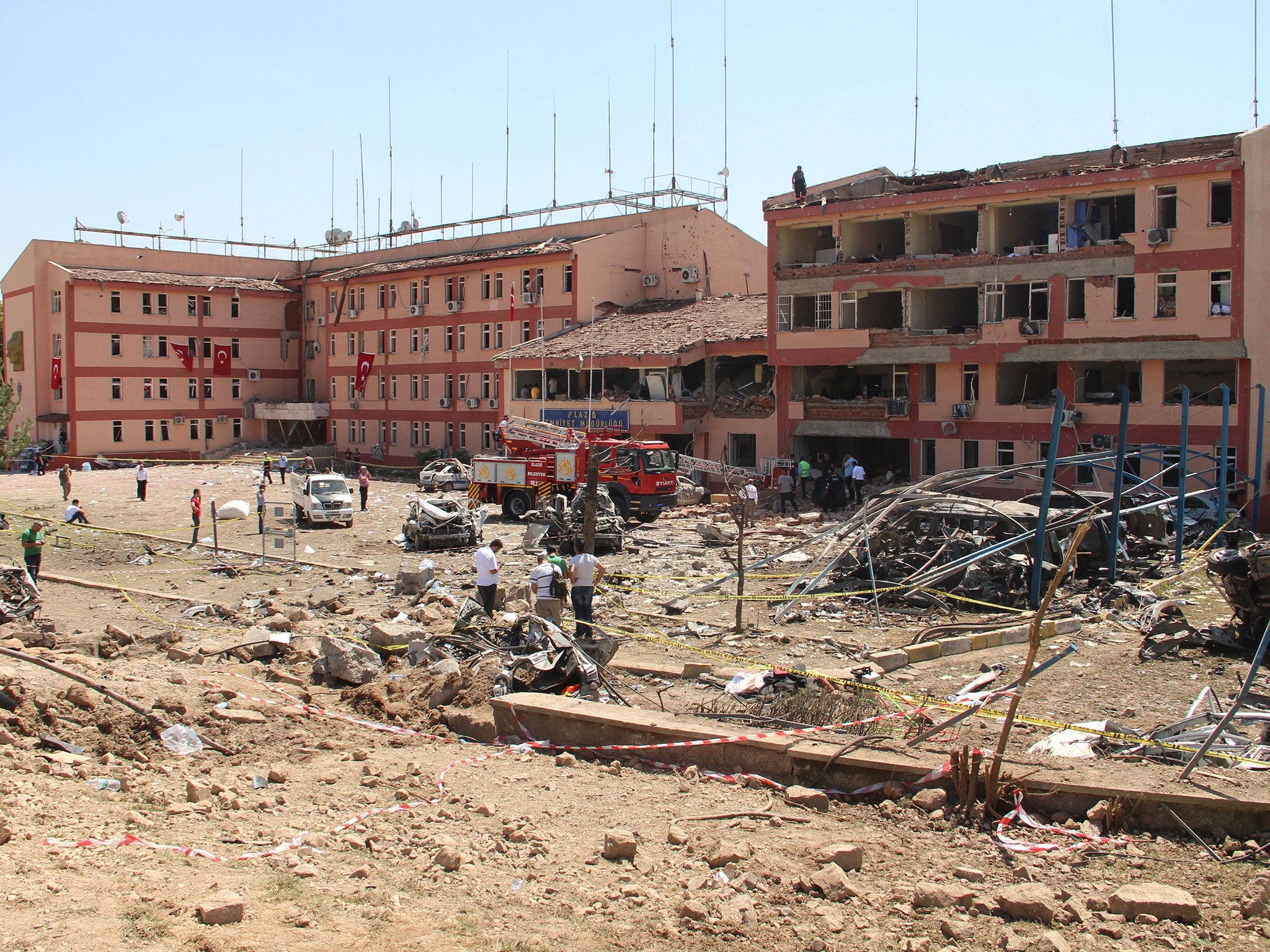 Officials work at the blast scene after a car bomb attack on a police station in the eastern Turkish city of Elazig, Turkey August 18, 2016.