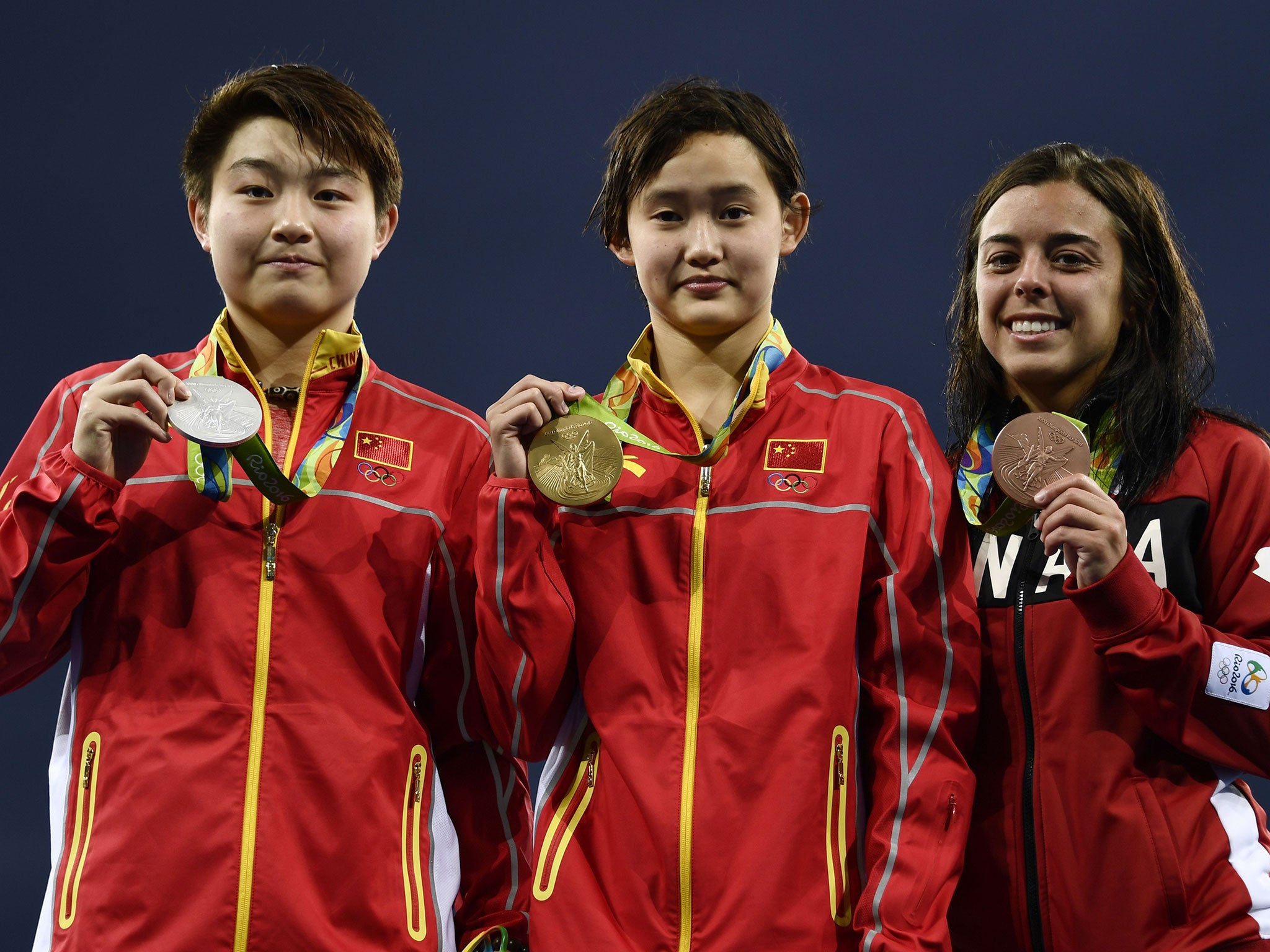 China's Si Yajie, Ren Qian and Canada's Meaghan Benfeito on the platform