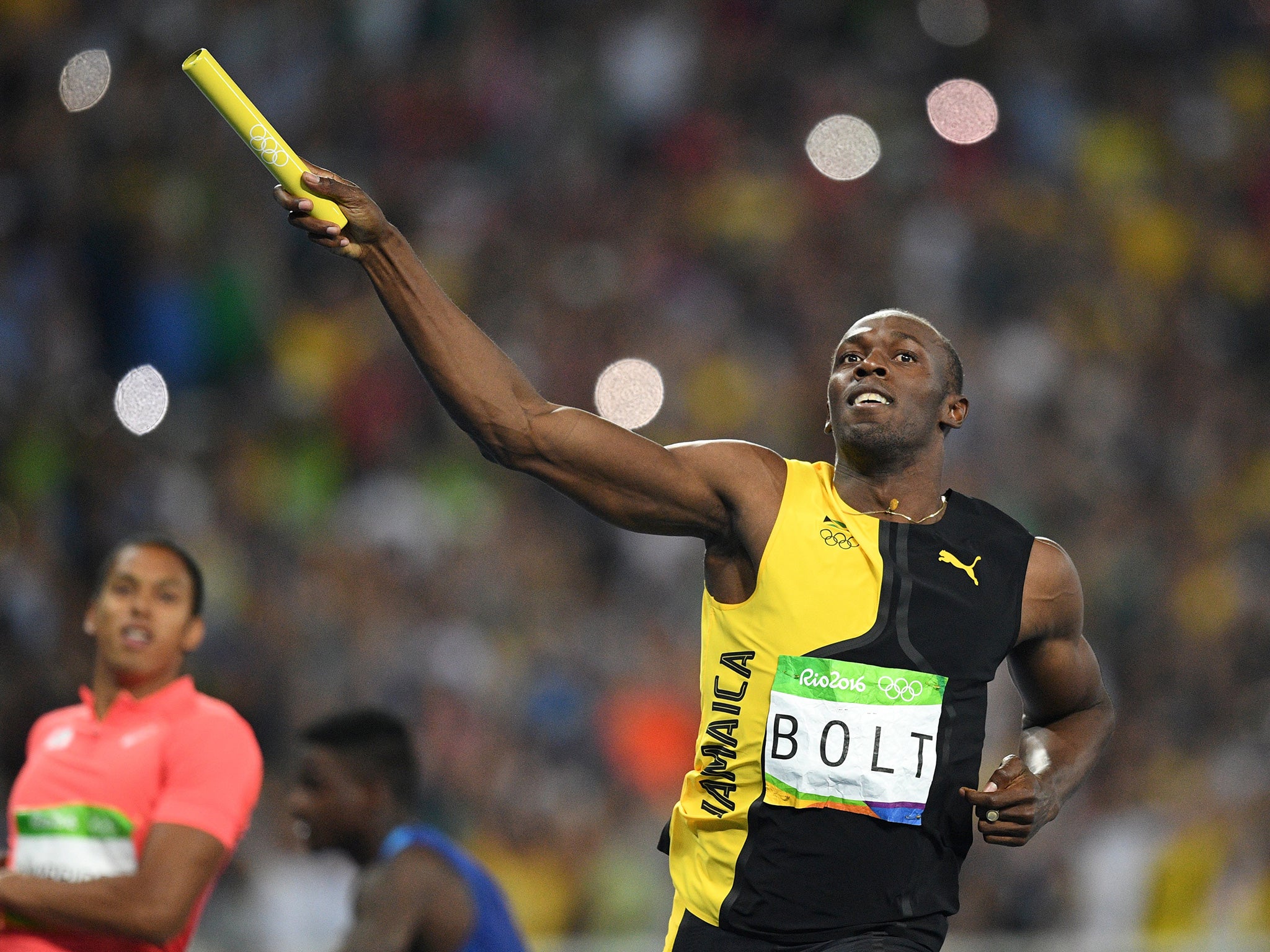 Bolt celebrates after crossing the line first in the men's 4x100m relay