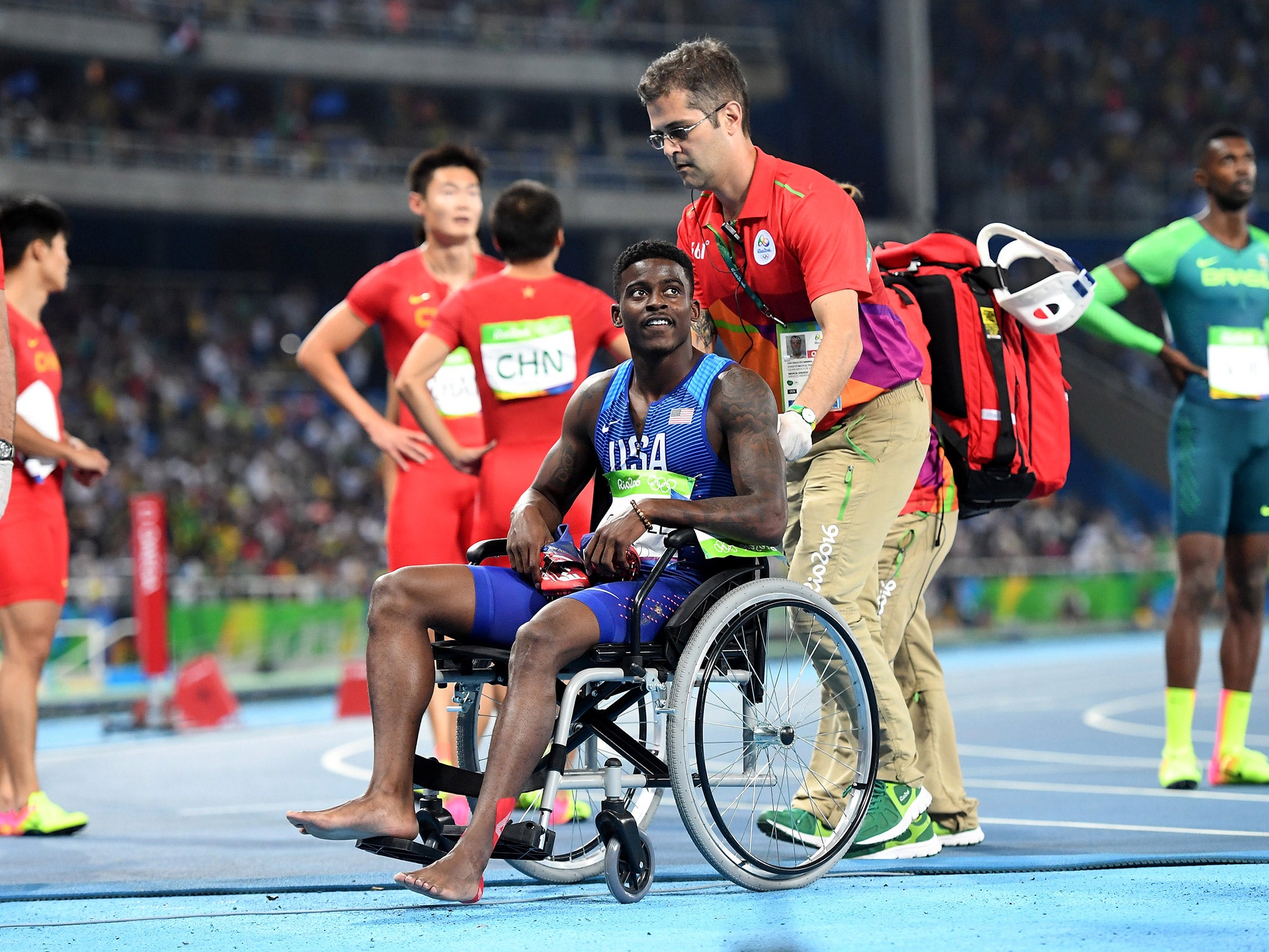 Trayvon Bromell has to be helped from the track after suffering a foot injury