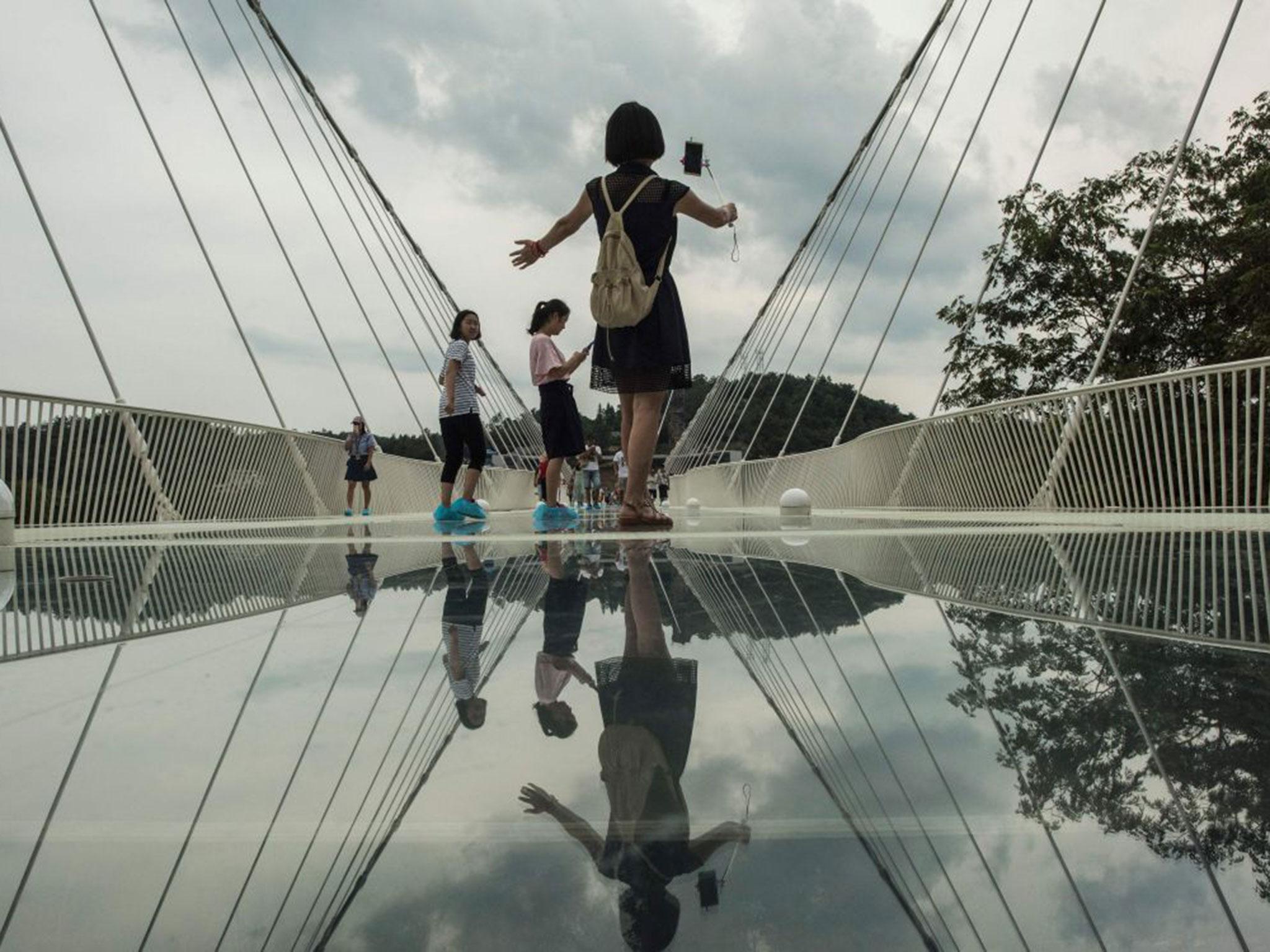 A woman takes a selfie on the bridge