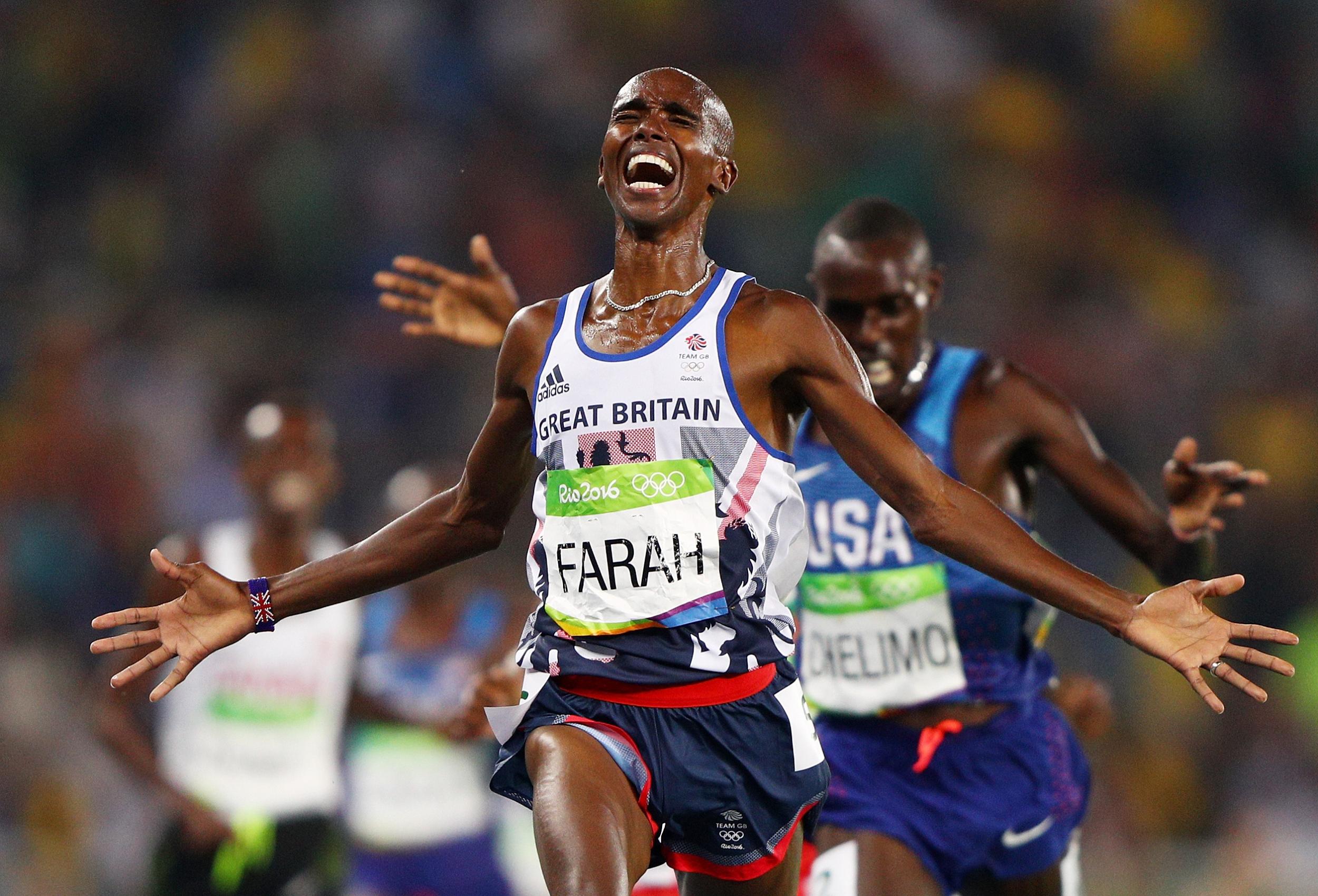 Mo Farah celebrates as he crosses the line