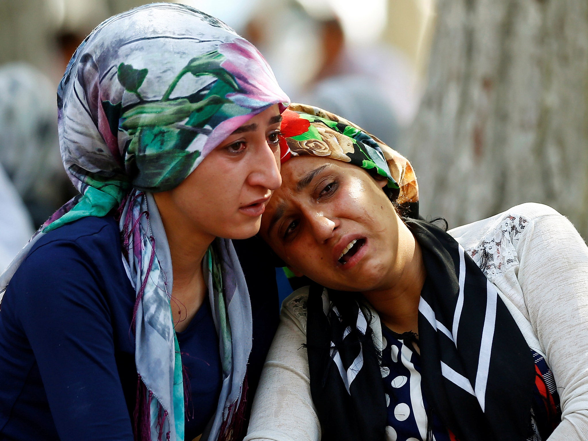 Women mourn as they wait in front of a hospital morgue in the Turkish city of Gaziantep