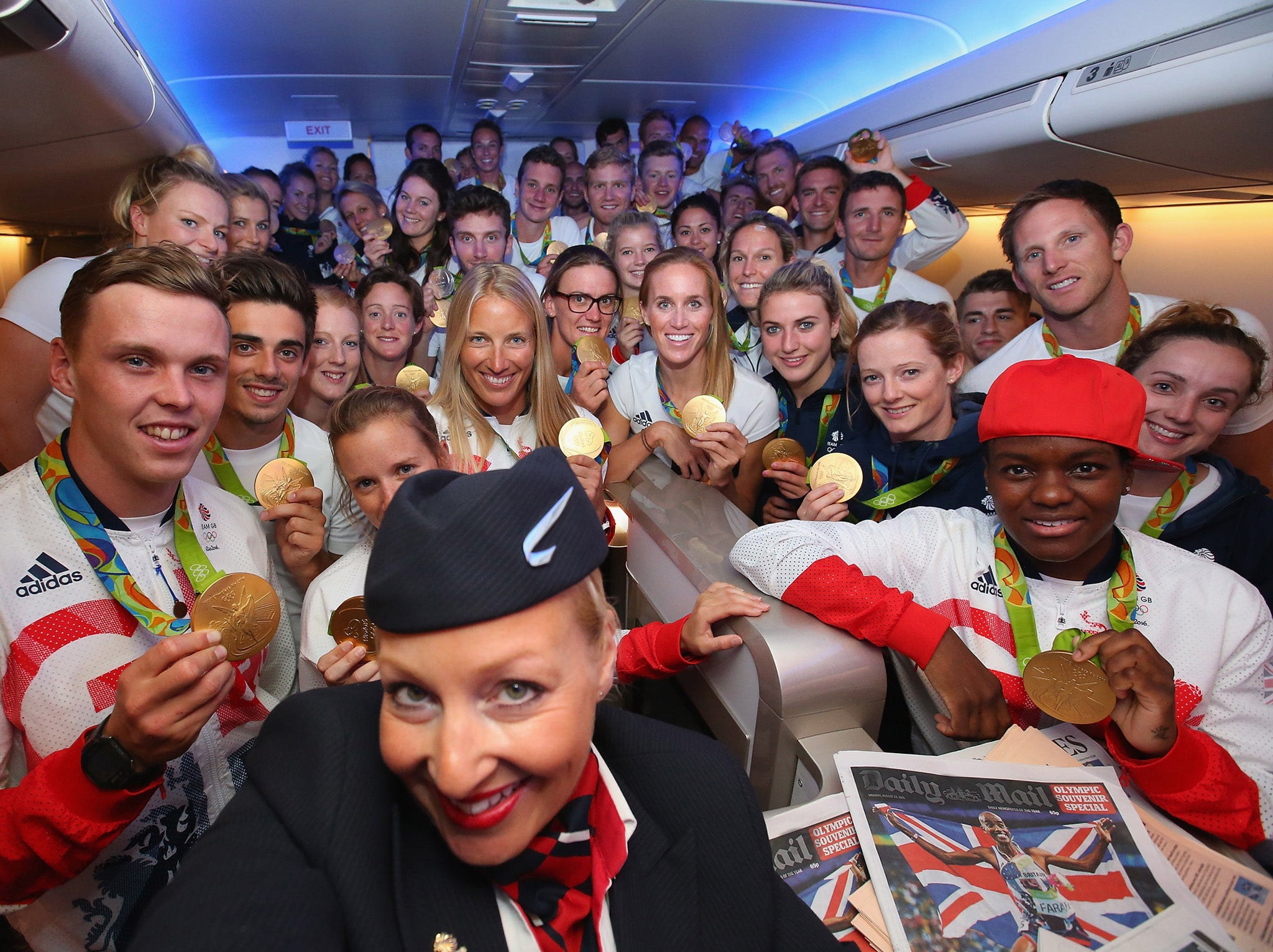 Gold medalists of Team GB pose for a selfie with a member of British Airways cabin crew (Getty)