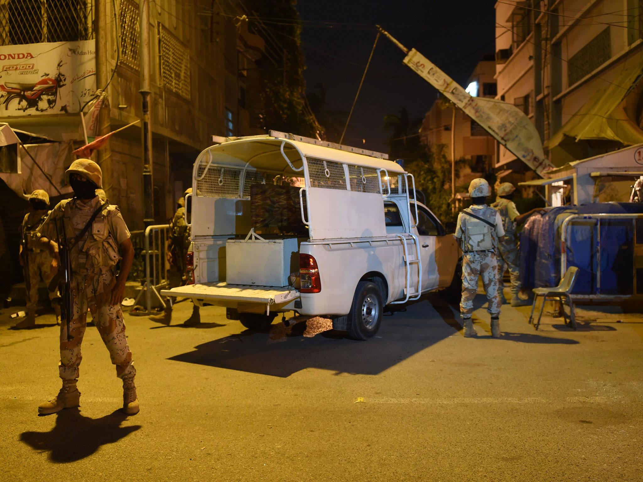 Pakistani paramilitary Rangers cordon off a street leading to the MQM headquarters in Karachi on Monday night