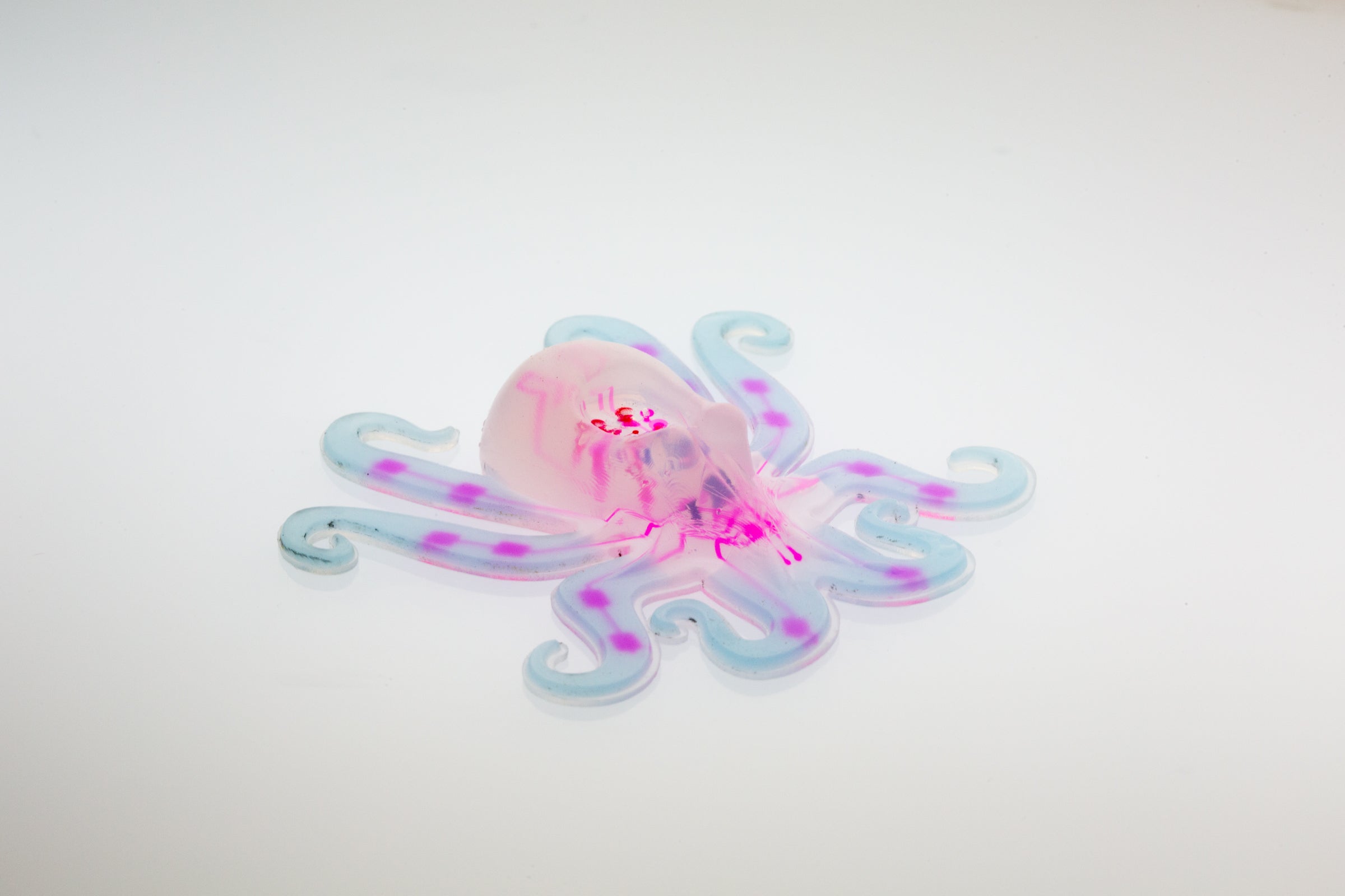 A pneumatic network (seen in pink) is embedded within the octobot’s body and hyperelastic arms can be seen in light blue