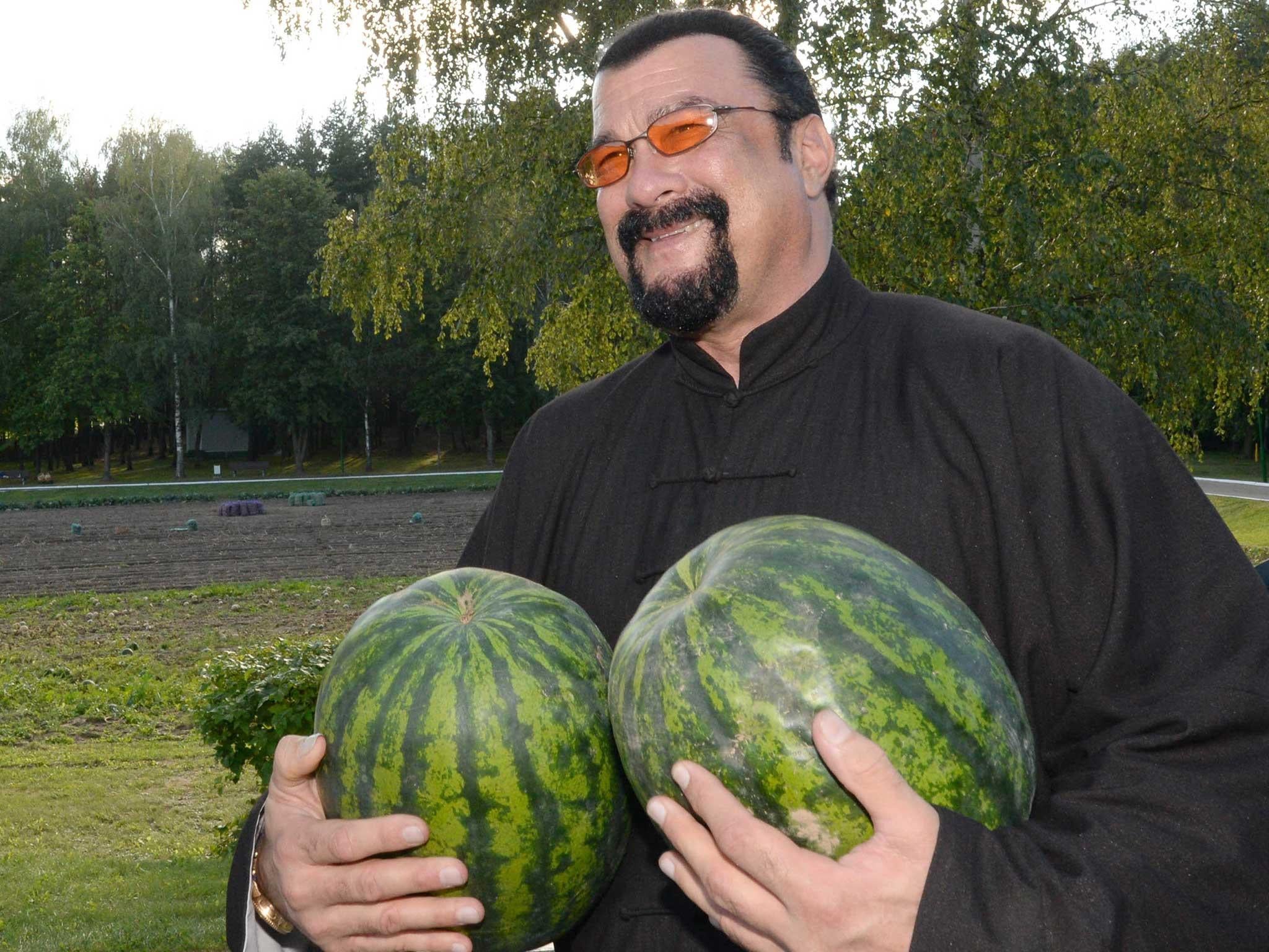 Hollywood actor and producer Steven Seagal holds two watermelons at the Belarus' presidential residence of Drozdy, outside Minsk